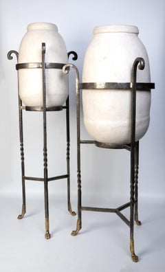 Pair of French White Pottery Urns Mounted On Wrought Iron And Brass Stands