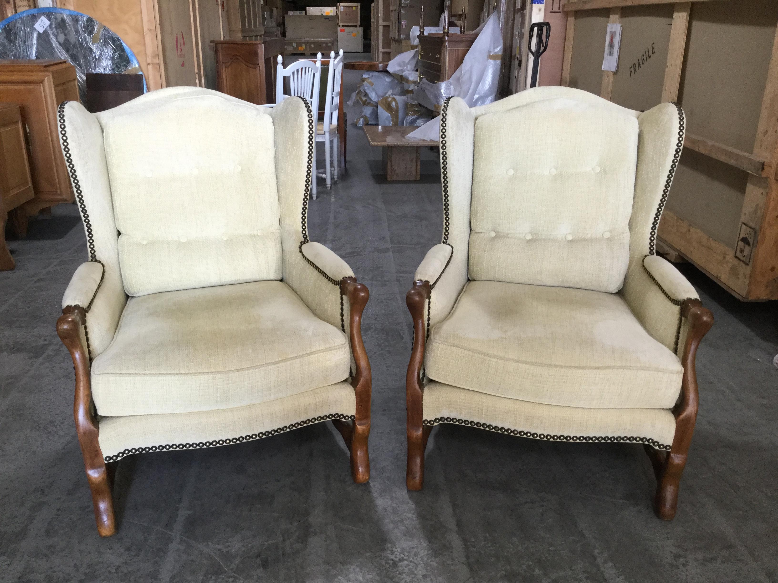 Handsome pair of French bergères chairs. Offering the utmost comfort, these chairs are wide, deep, and inviting. While remaining stylish. Newly upholstered in an off-white velvet chenille fabric, these chairs are built of French oak with Louis