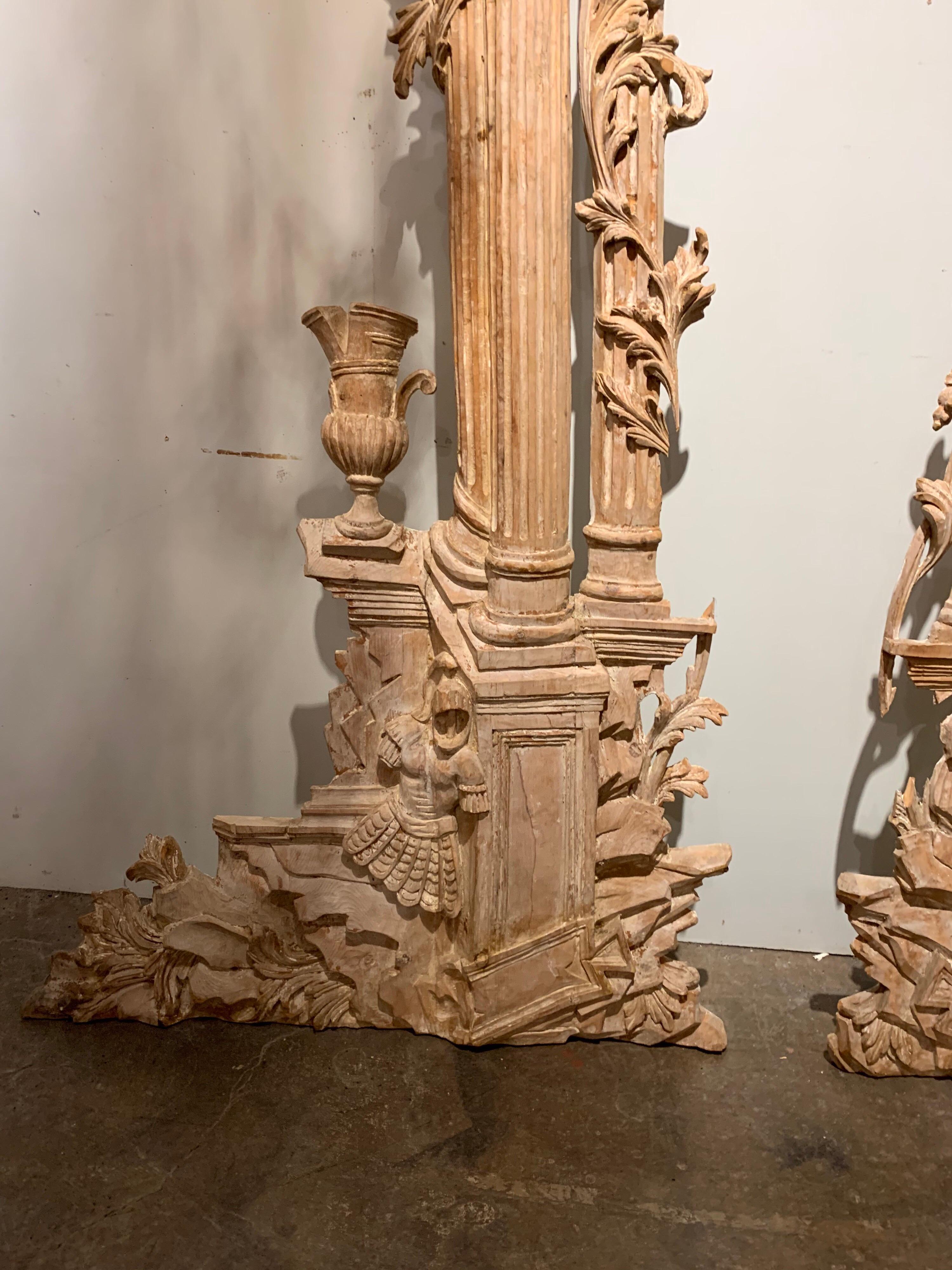 Great pair of carved white-washed decorative elements. Amazing carving on these interesting architectural elements. Images include pillars, urns, acanthus leaves and soldiers. There are some scattered losses to the piece.
  
