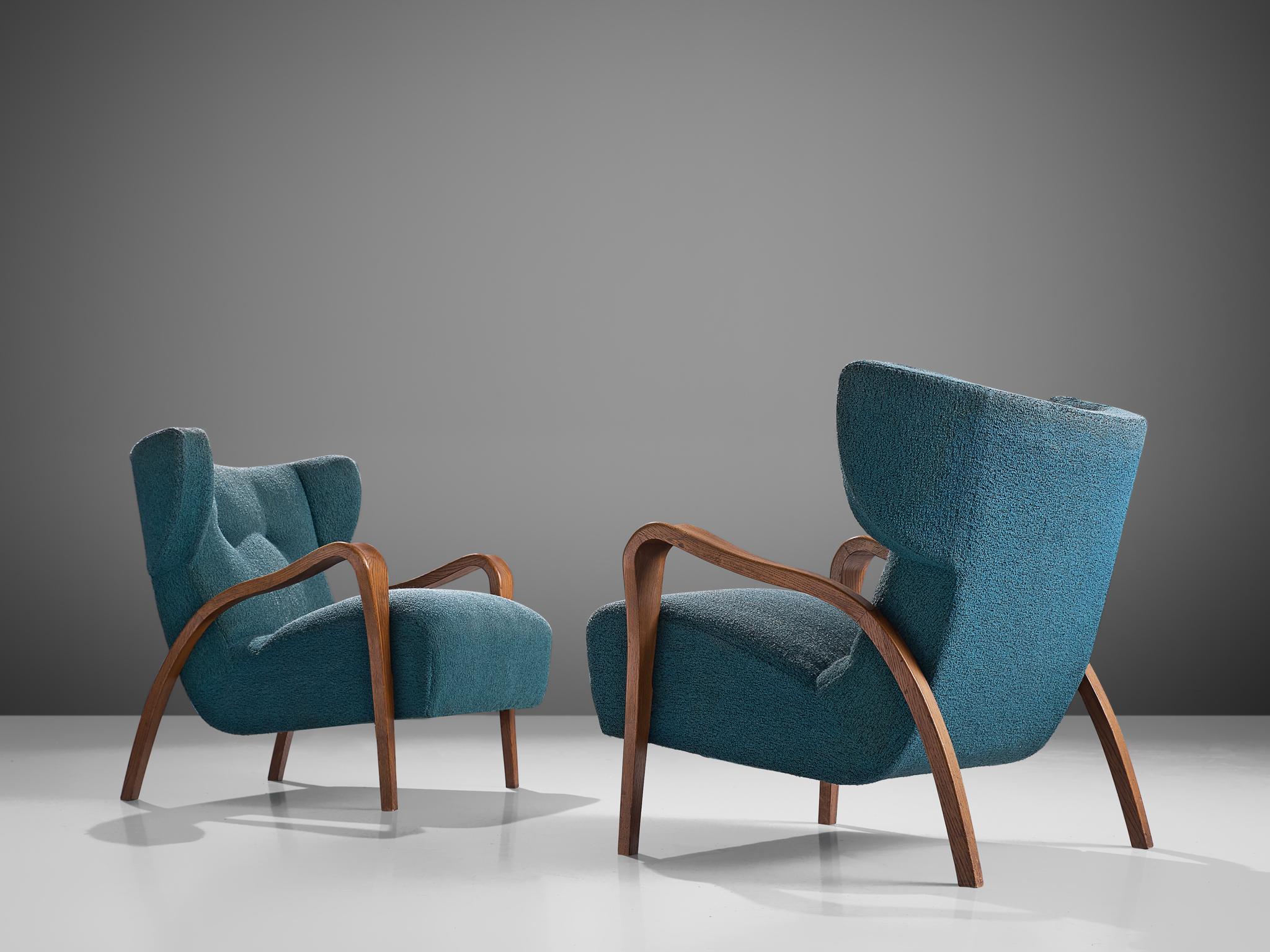 Pair of low wingback chairs to be reupholstered, oak and fabric, France, 1950s

Strudy and bulky set of French armchairs that features low wing backrests. The chairs are from late Art Deco period, as they show its distinctive characteristics, such