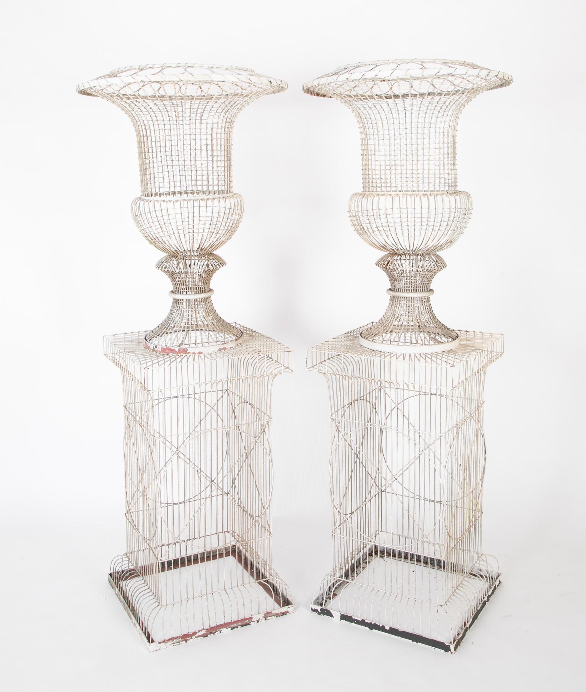 A pair of fabulous French wire urn form planters on base.