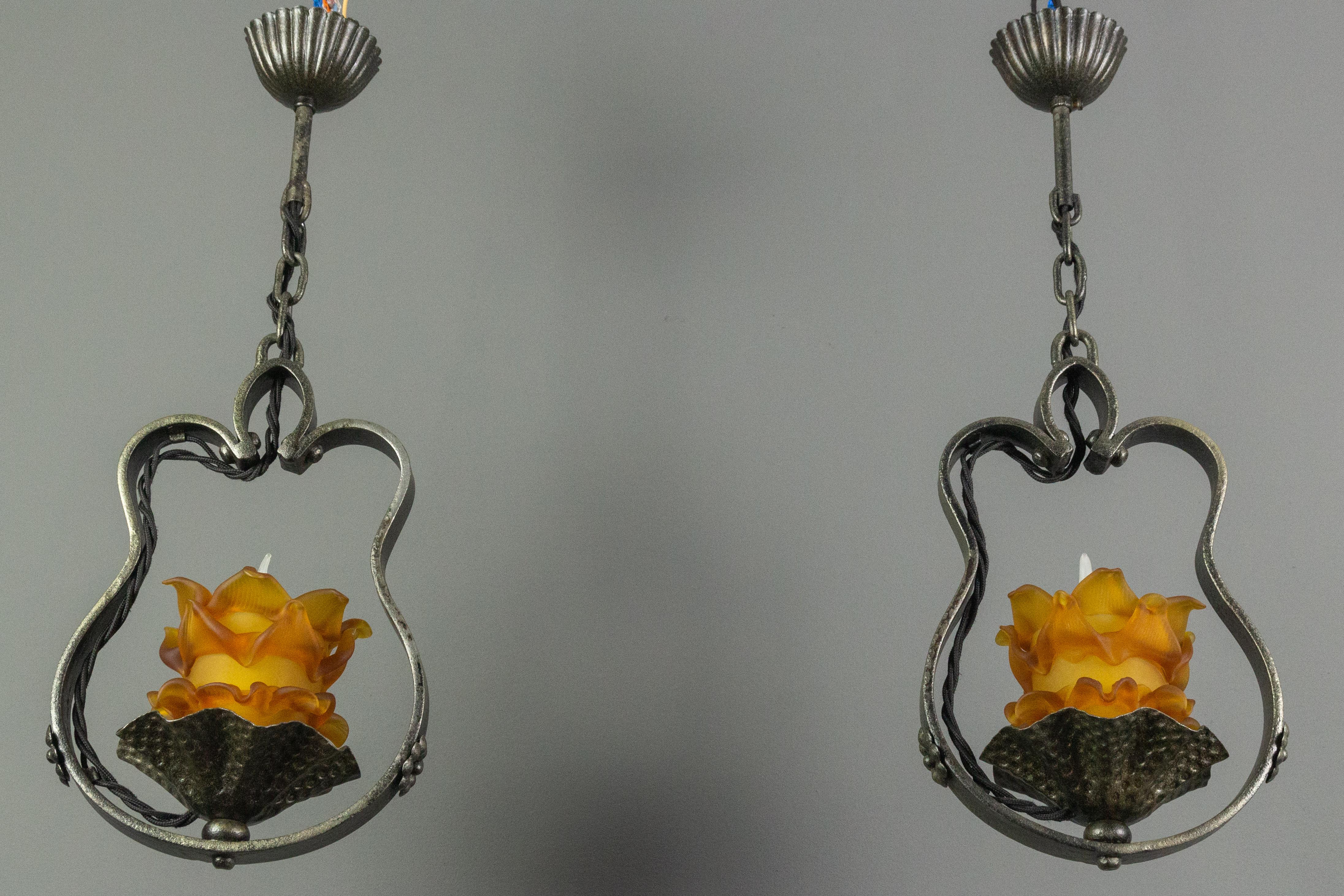 Mid-20th Century Pair of French Wrought Iron and Orange Glass Flower Shaped Pendant Lights