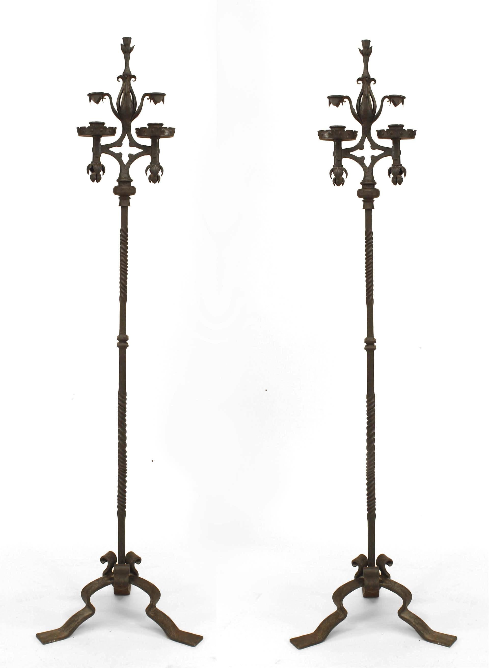 Pair of French Victorian (19th/20th Century) wrought iron 2 light candle stands with foliate details supported on 3 legs (PRICED AS Pair).
