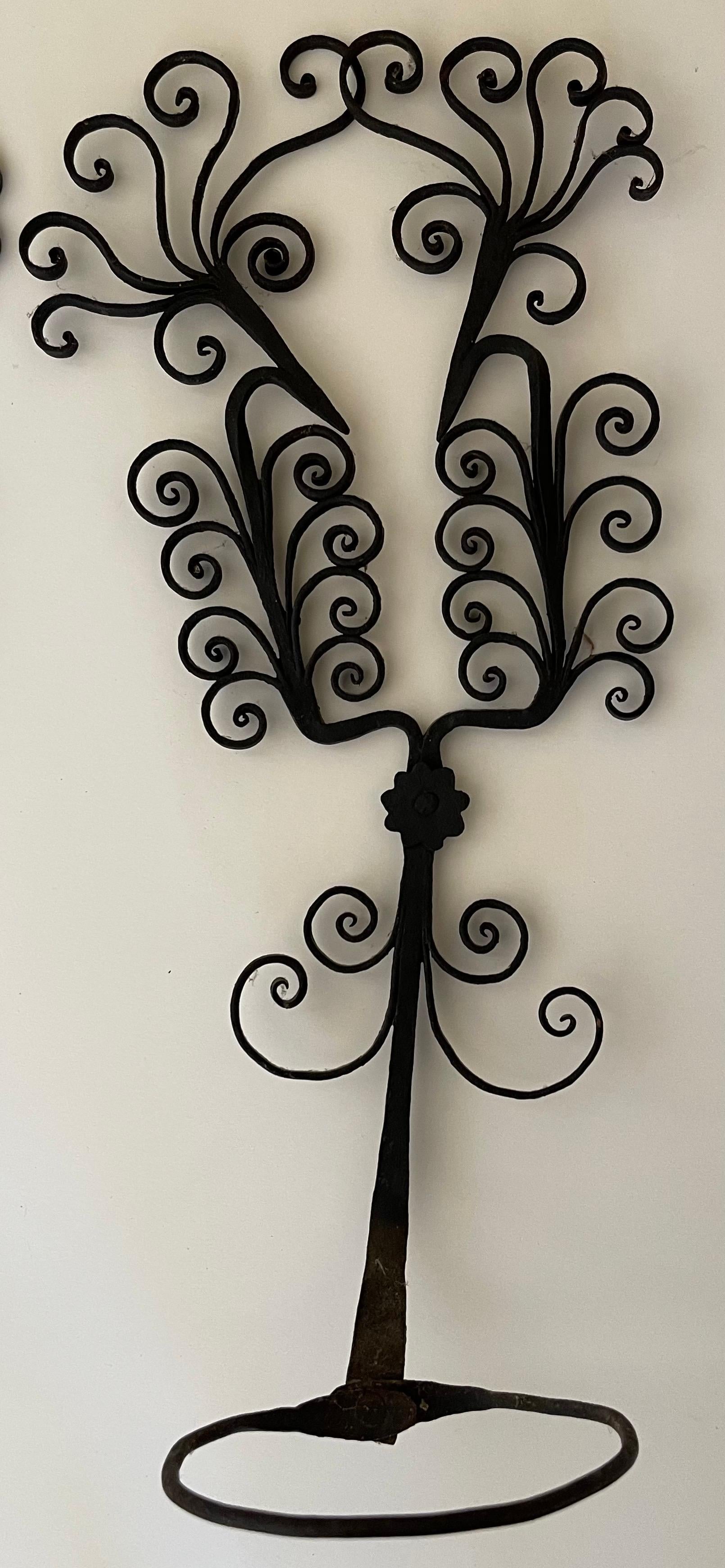 Pair of 1930s French wrought iron scroll motif wall mounted plant holders. Black wrought iron with detailed scrolled design. Each piece is handmade and varies slightly. No makers mark or signature. Hanging hardware is not included. 