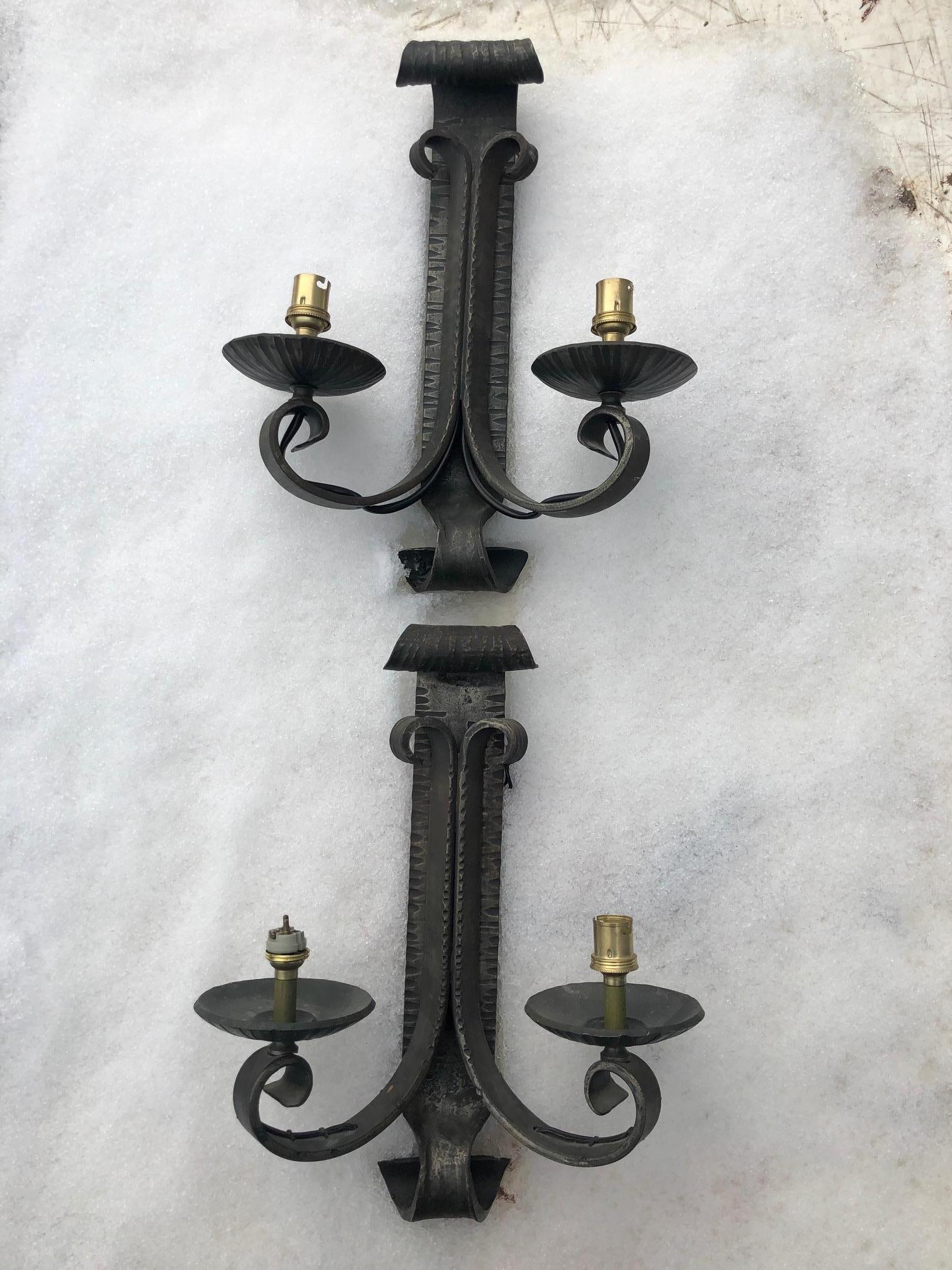 Pair of sconces from the 1940's in hammered wrought iron with its original patina.