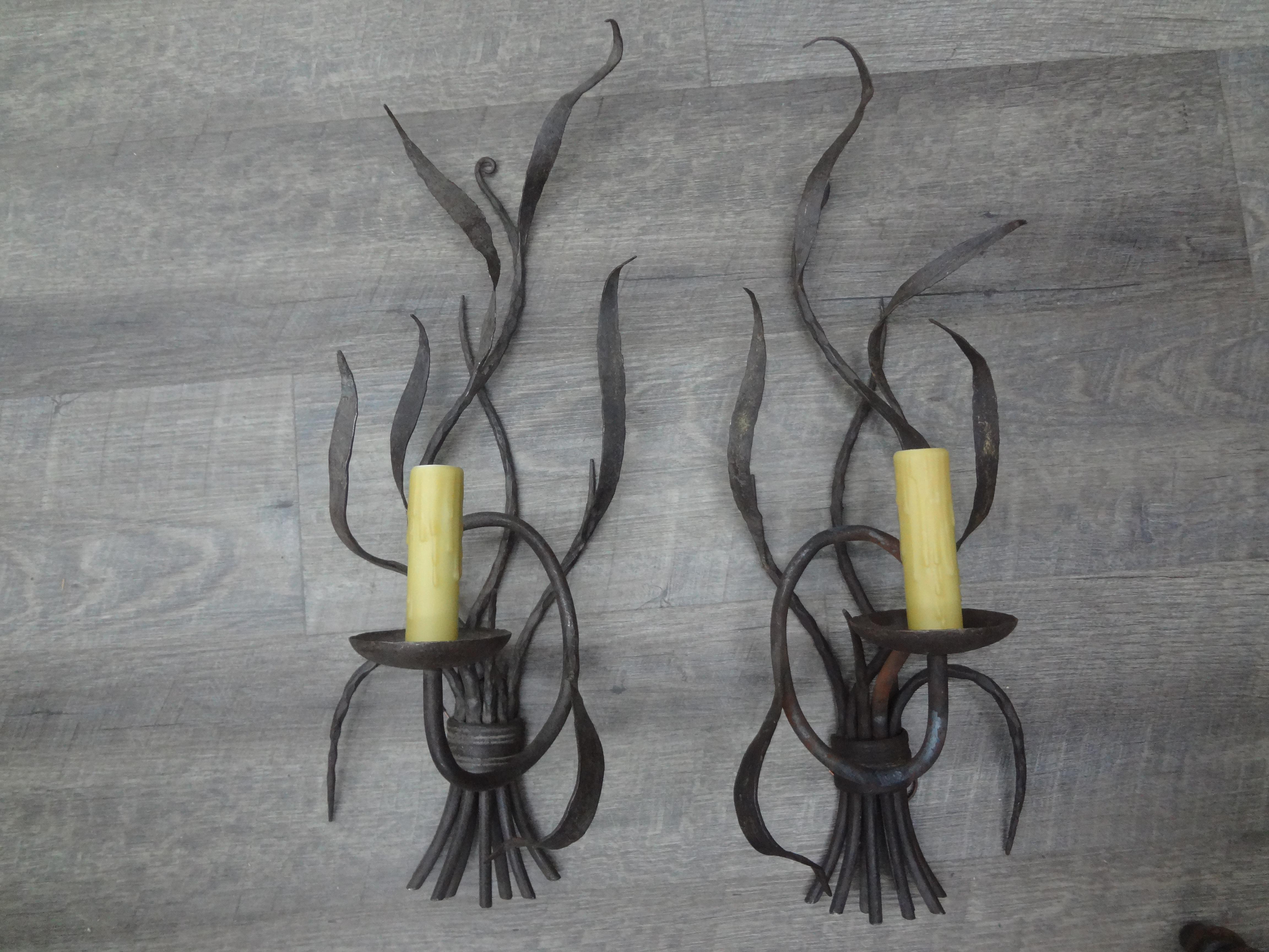 Pair of French wrought iron sconces.
This lovely pair of French Brutalist style wrought iron sconces each feature a single candelabra socket with polywax sleves. Our featured sconces have been newly wired with new sockets for the U.S. market.
Great