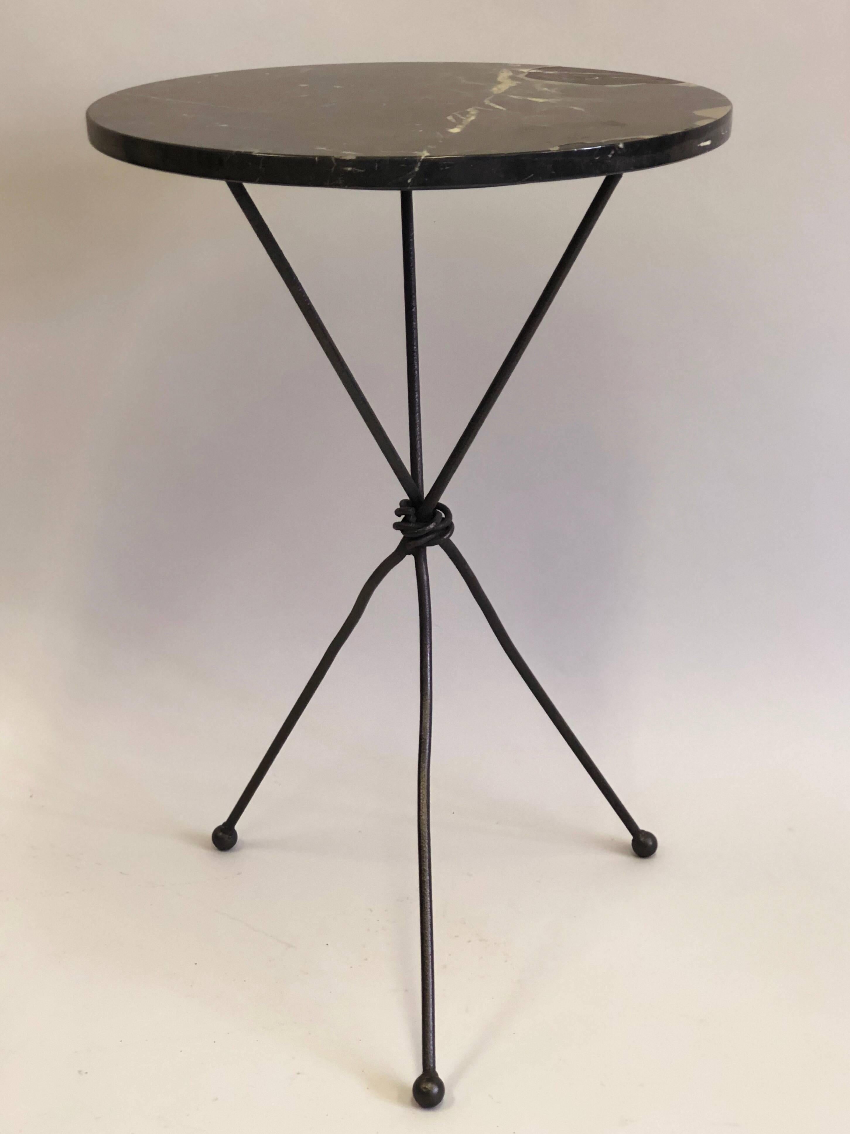Pair of French hand-wrought Iron end or side tables or gueridons in the style of Alberto and Diego Giacometti for Jean Michel Frank.

The tables are composed of handmade wrought iron with the legs poetically set un-evenly apart forming a tripod