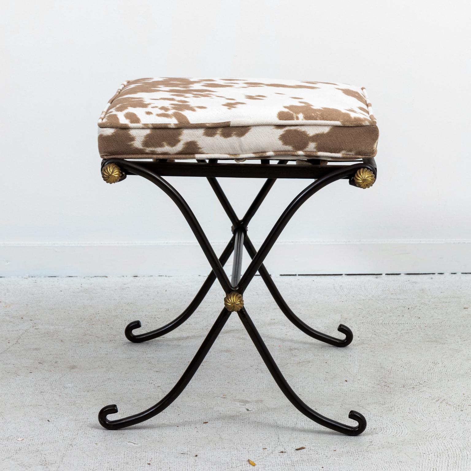 Wrought iron benches with brass ball medallion accents and faux hide print upholstery, circa mid-20th century. Made in France in the French Directoire style.