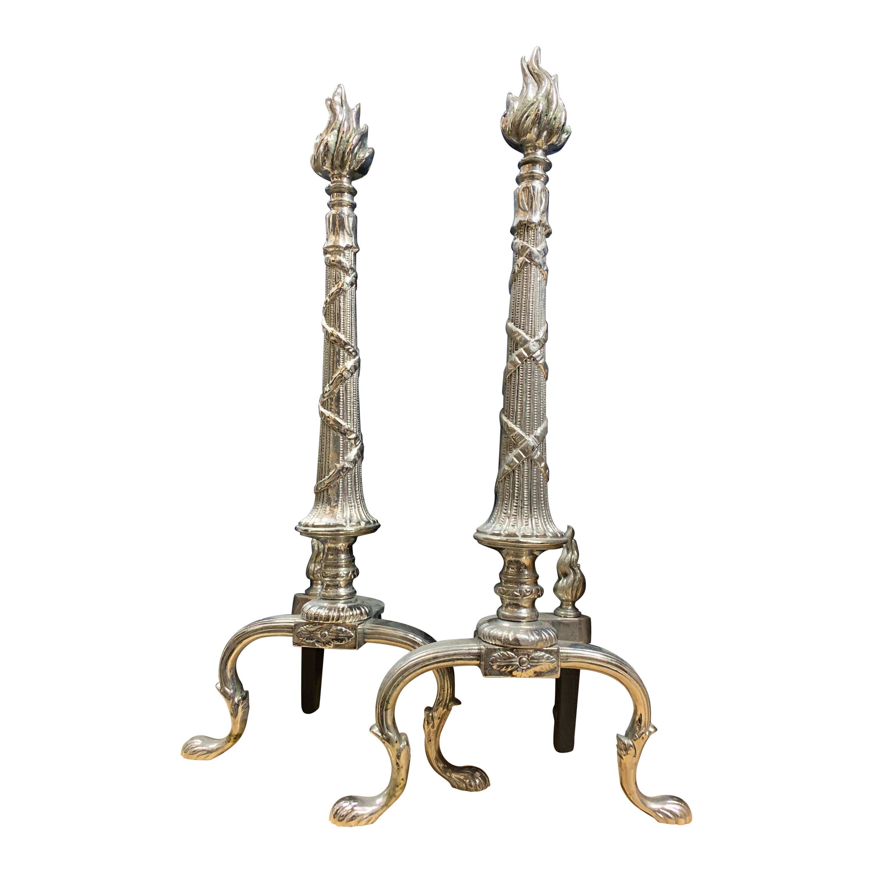 Pair of French X-Andirons with Flame Head For Sale
