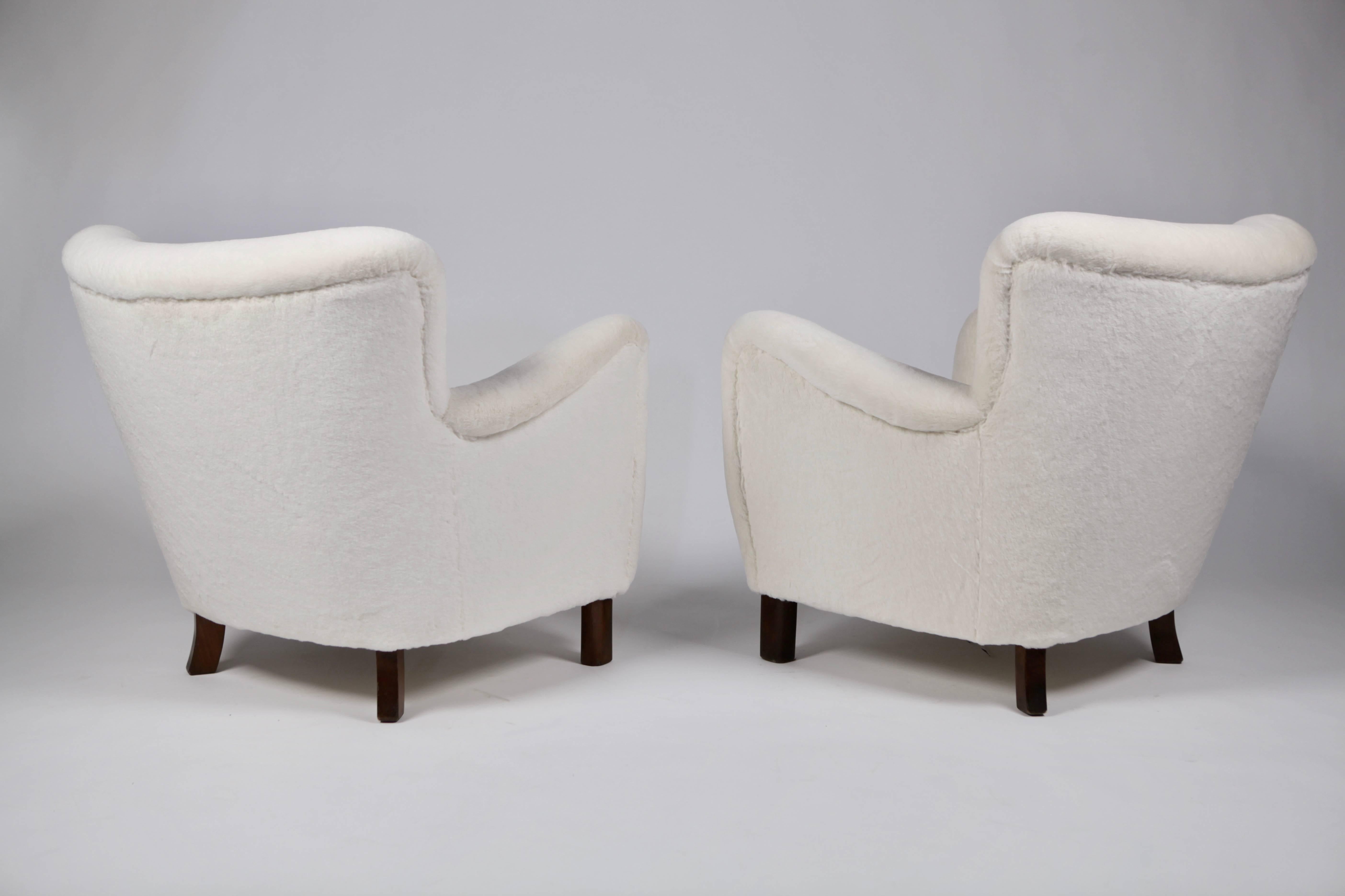 A pair of sculptural easy chairs.

Designed 1938 and made by Fritz Hansen in the 1940s.

Legs of stained beech, new upholstery in Angora Mohair.

Excellent condition.