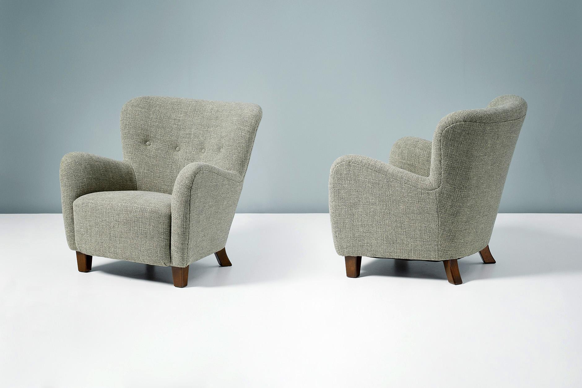 Fritz Hansen

Model 1669 Variant Armchairs, c1950s

Pair of armchairs produced by Fritz Hansen in Denmark in the 1950s. This model is a variant of the Model 1669 chair with a more curved back and tapered stained beech legs. The chairs have been