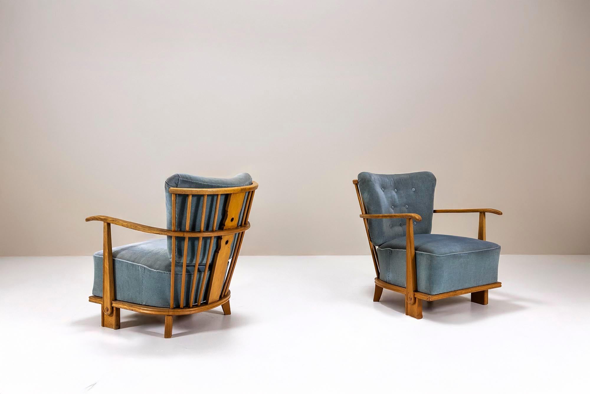 Rare and magnificent; this pair of Model 1590 lounge chairs was produced in the 1940s by Fritz Hansen, the famous Danish furniture manufacturer. The Model 1590 lounge chairs carry significant historical weight in the narrative of Danish modern
