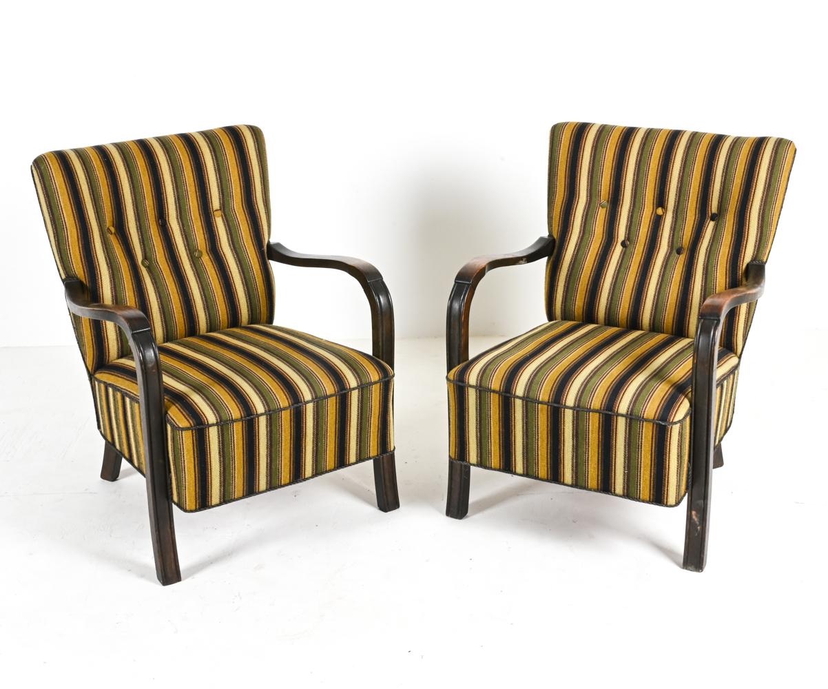 Step into a world of vintage charm and Danish elegance with this exquisite pair of Fritz Hansen-style Beechwood Easy Chairs. A tangible ode to the 1940s—a period rich in artistry and imagination—these chairs invite you to sit, to reminisce, and to