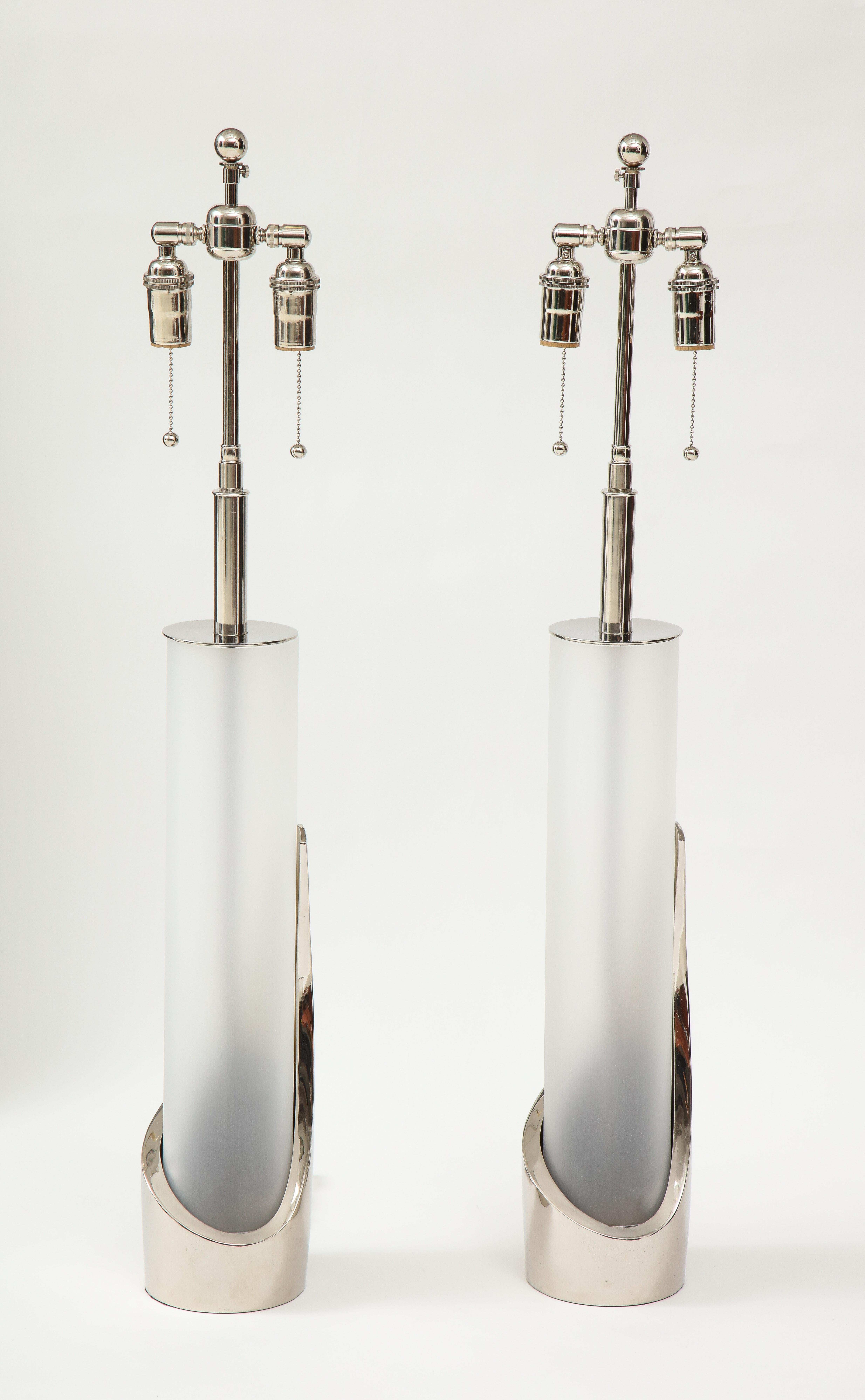 Pair of cylindrical chrome and glass lamps by Laurel.
The polished chrome lamps have frosted glass inserts and they have been
Newly rewired with polished chrome adjustable double clusters that take
standard size light bulbs.