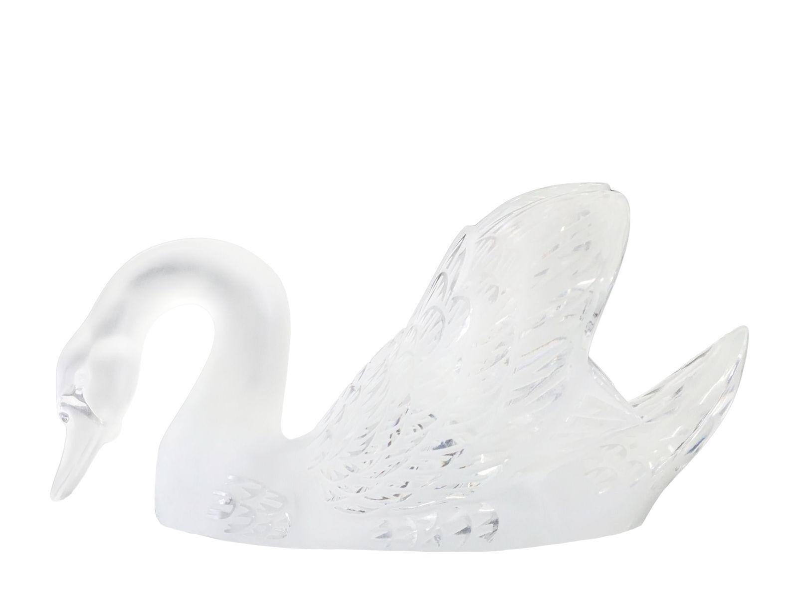 Elegant pair of frosted glass centerpiece swan figures made by Lalique made in France during the 21st century.
Each swan features a delicate frosted glass finish, adding an elegant touch to any interior setting. The base of each figure is engraved