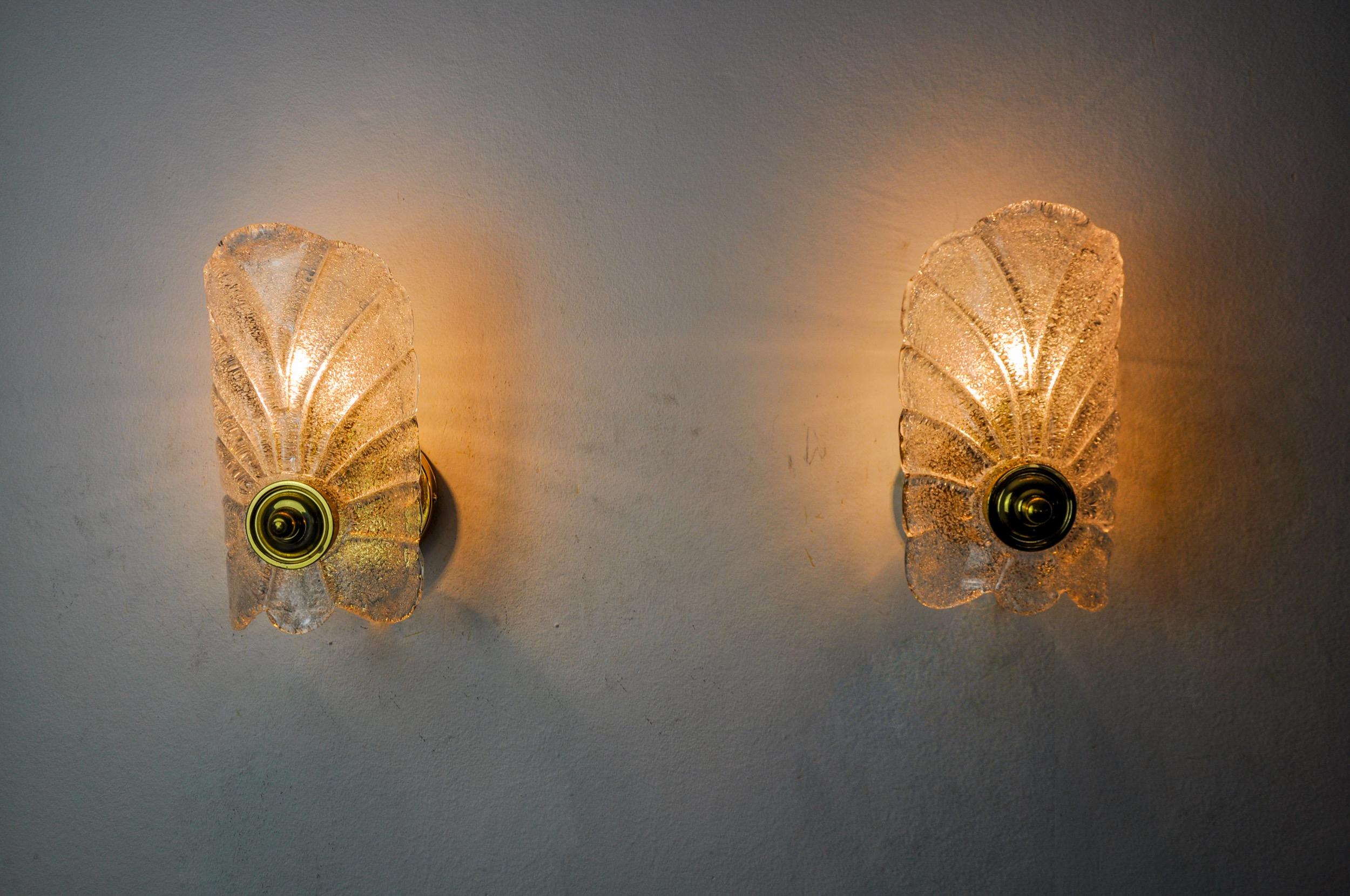 Very beautiful pair of leaf sconces designated and produced in italy in the 70s. Murano glass crystals frosted effect in leaf shape and gilded metal structure. Unique object that will illuminate wonderfully and bring a real design touch to your