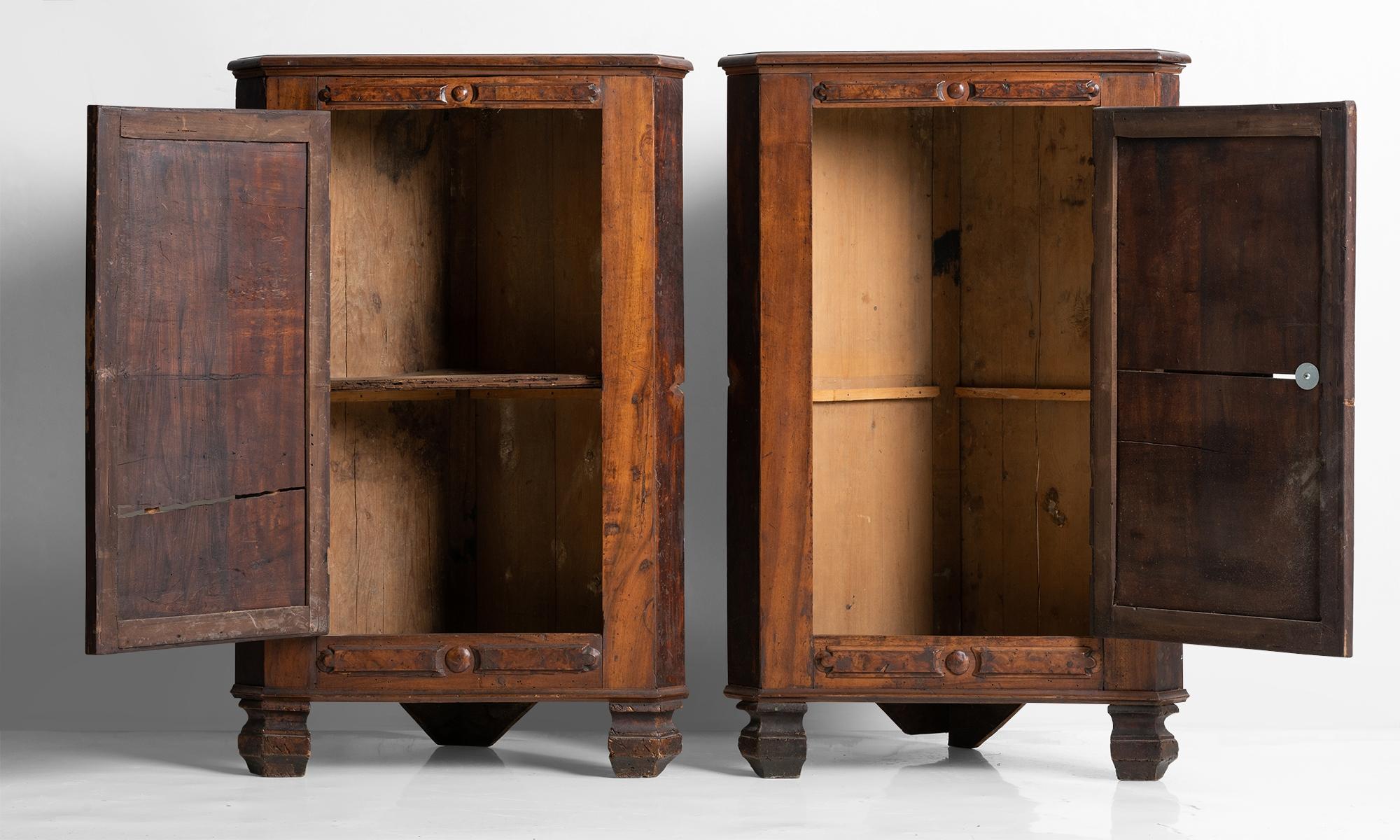 Handcrafted fruitwood corner cabinets with elegant carving.