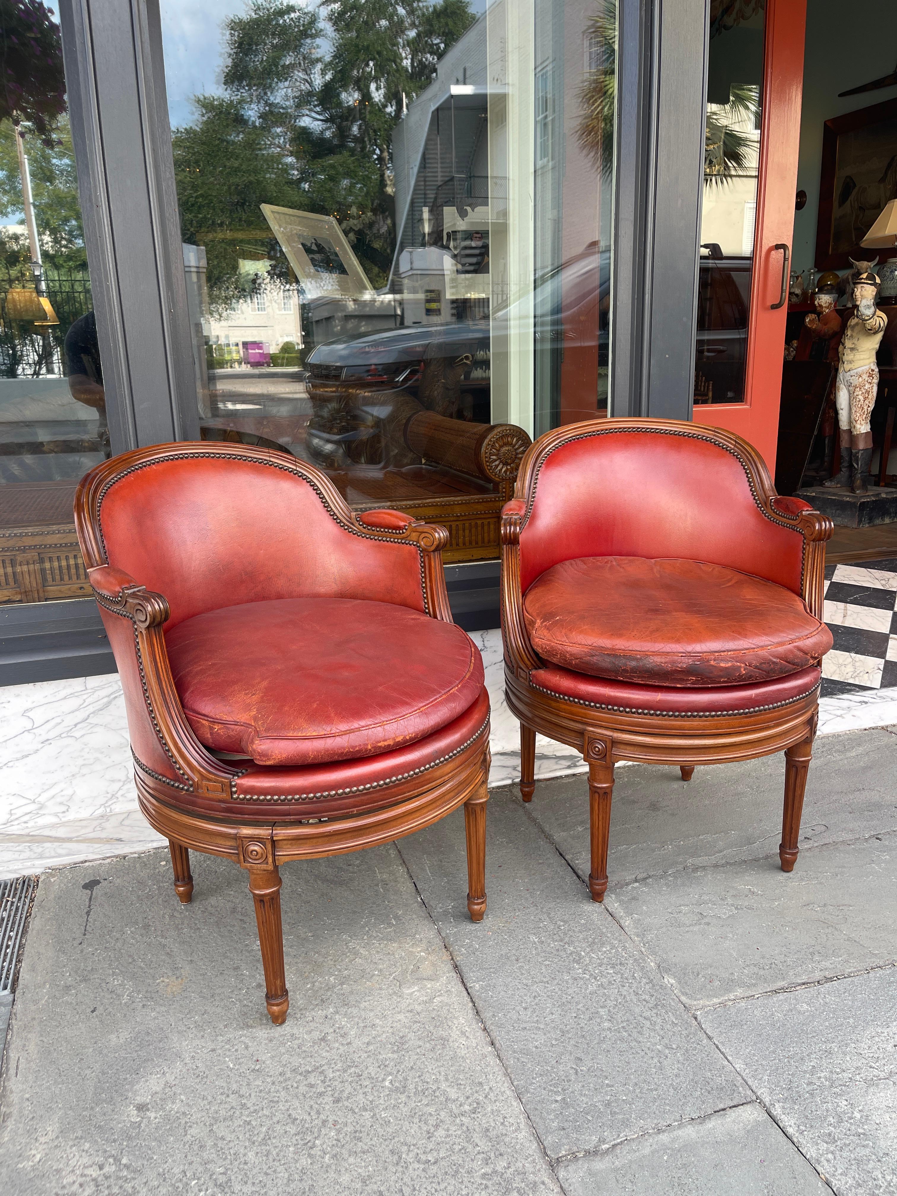 French Pair of fruitwood swivel chairs in ox blood leather with Gouffe label