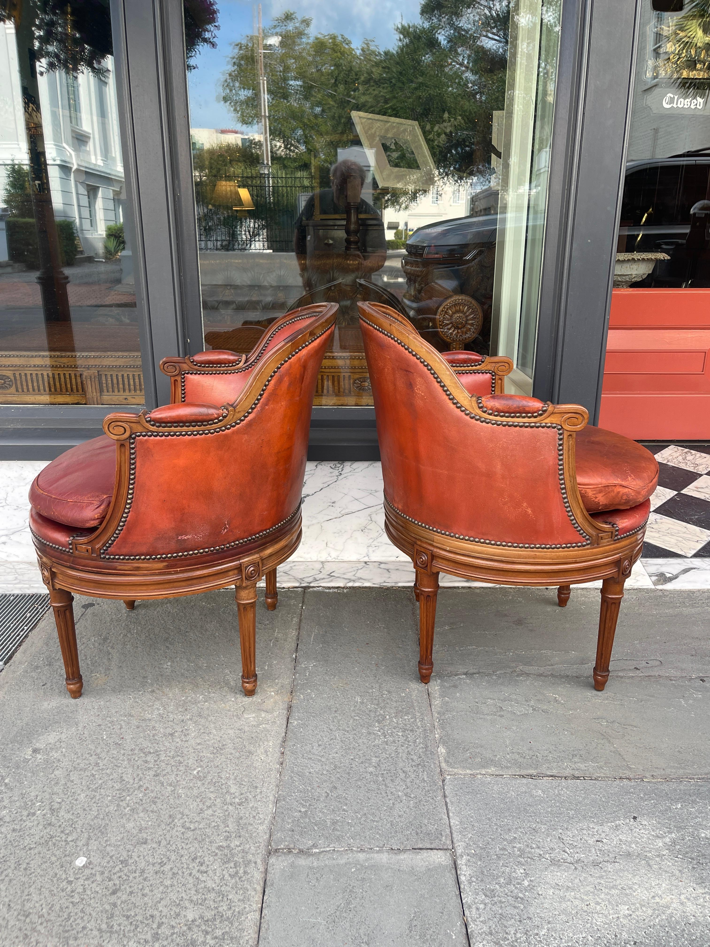 Pair of fruitwood swivel chairs in ox blood leather with Gouffe label In Good Condition In Charleston, SC