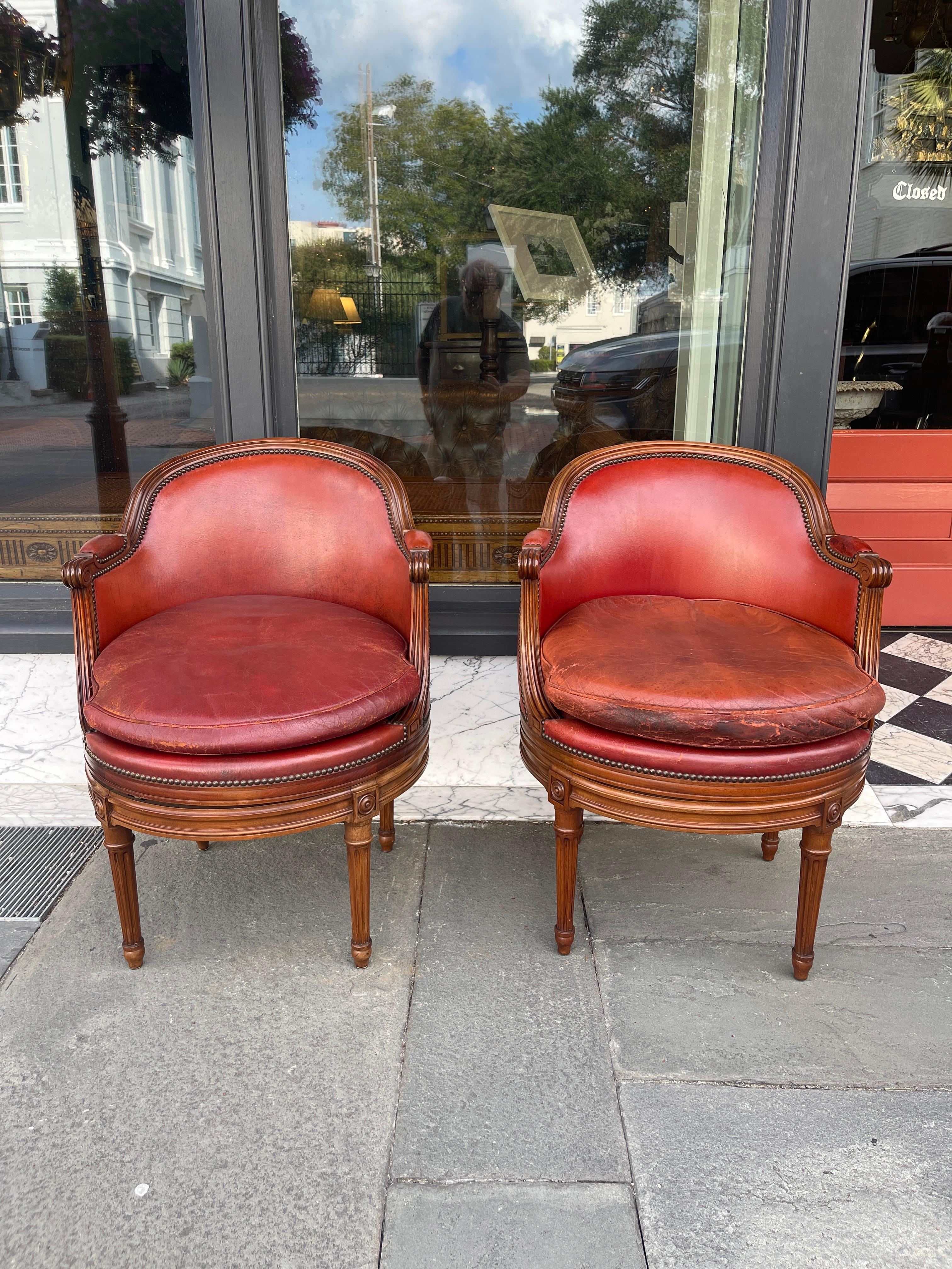 20th Century Pair of fruitwood swivel chairs in ox blood leather with Gouffe label
