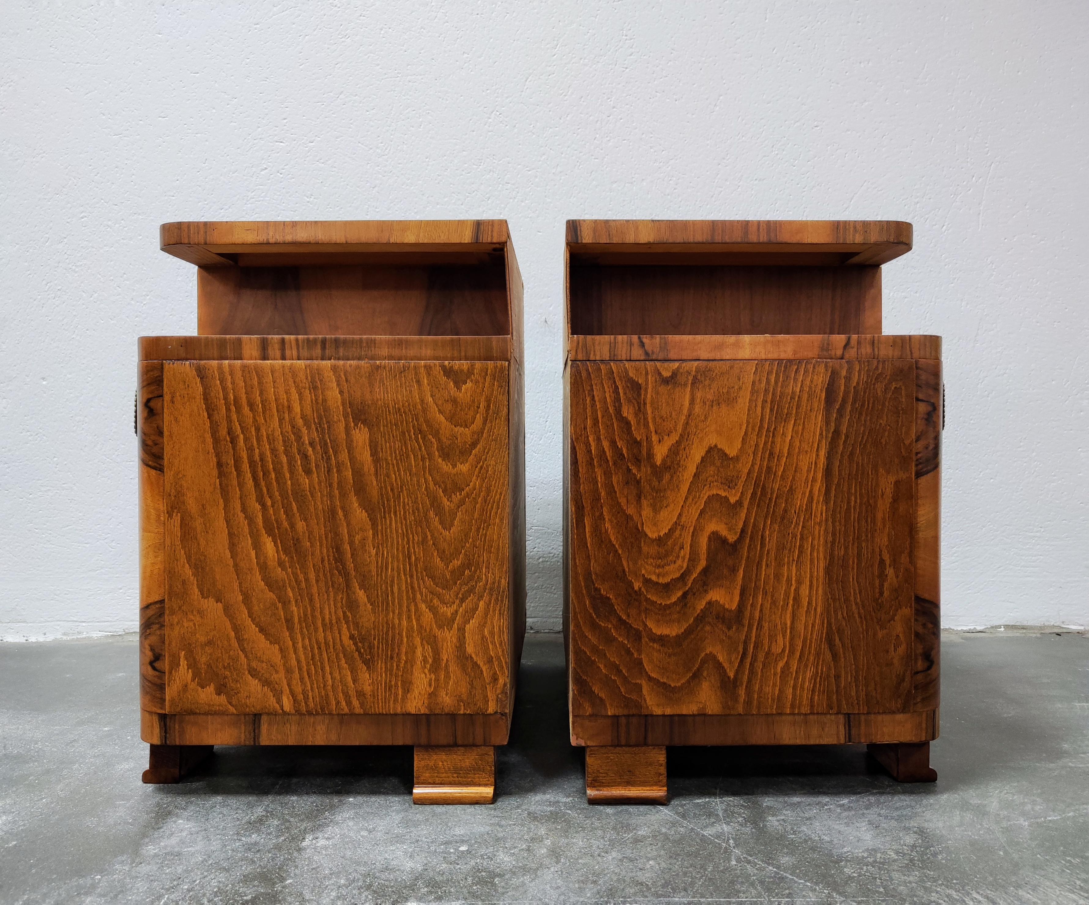 In this listing you will find a pair of gorgeous Art Deco Nightstands. They feature asymmetrical shape, with one small drawer and a cabinet beneath it. The top and the doors of the nightstands are done in walnut roots (burlwood) veneer and feature