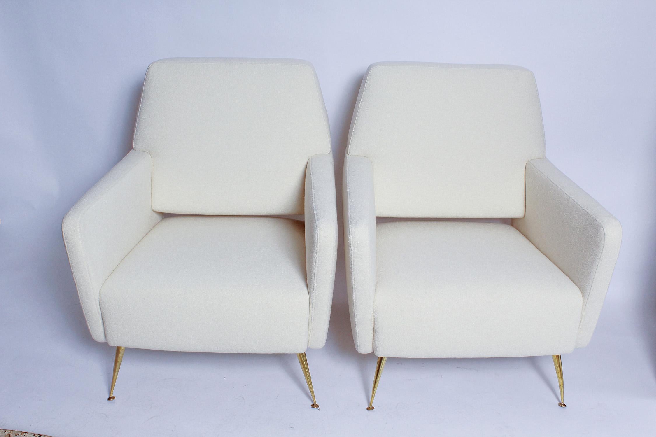 A super-chic pair of 1950s Italian Modernist lounge chairs, fully restored, with all new foam, polished brass legs, and Beacon Hill super-fine wool bouclé upholstery. We've lusted after these chairs ever since we spied them in a Parisian apartment