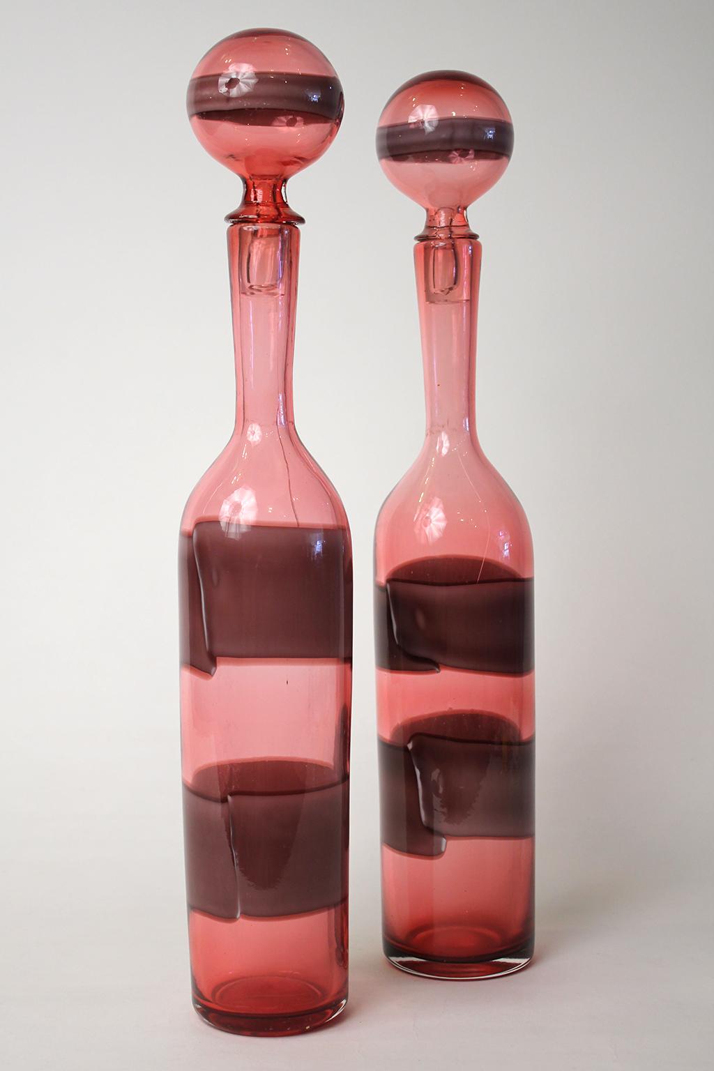 Beautiful pair of matching Fasce Orizzontali bottles with stoppers by Fulvio Bianconi for Venini. Seldom seen color. Both bottle have faint hairline cracks that almost appear to be original from when they were made. Please see photos. There are no