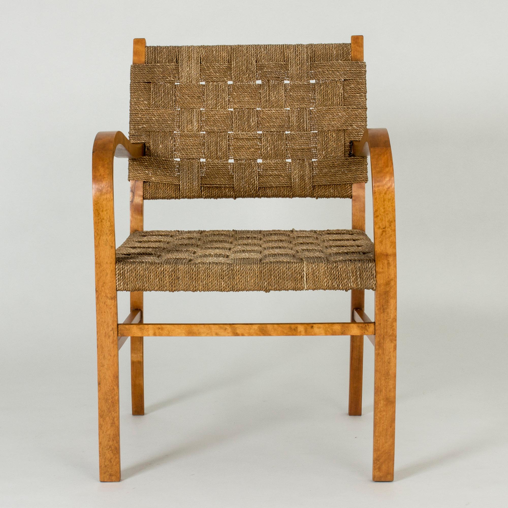 Beautiful functionalist armchair by Axel Larsson, with curved armrests creating a lovely, open silhouette. Made with a stained wooden frame and rope seat and backs. The seat has been reupholstered.