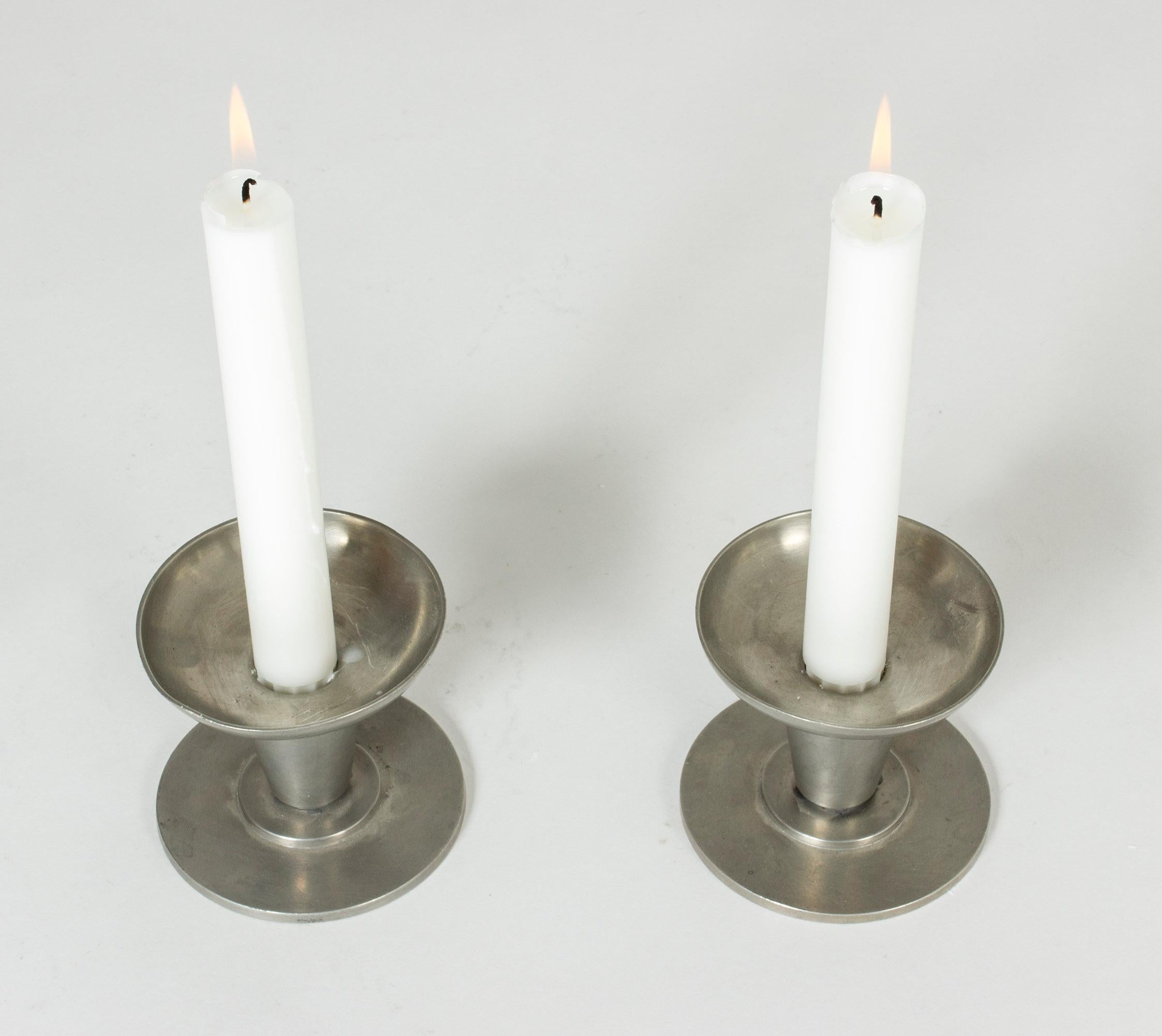 Pair of functionalist pewter candlesticks from GAB, in an appealing, strict and round design.