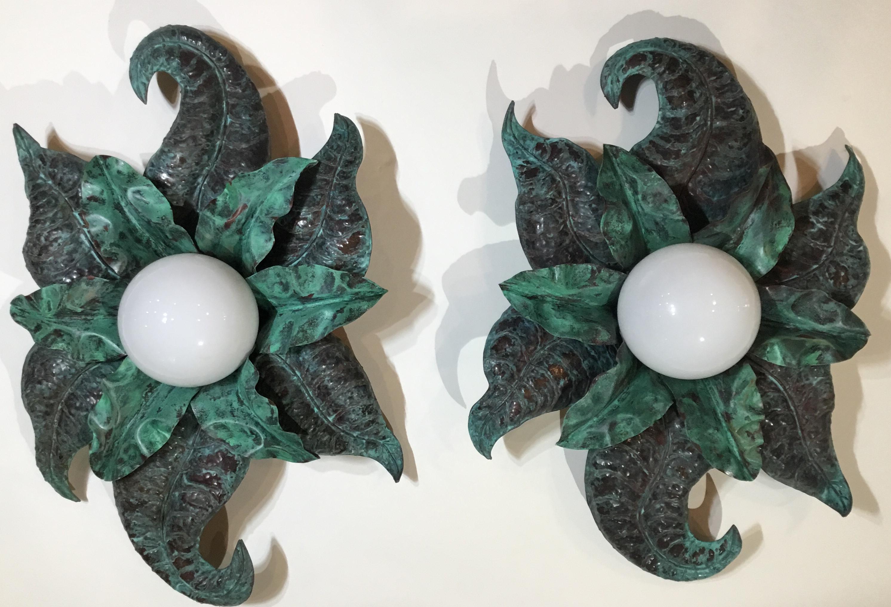 Exceptional pair of vintage wall scones artistically hand crafted of two layers of copper leaves ,newly electrified with one 6-/watt light each cover with milk glass ball , and ready to use .one of a kind object of art to hang on the wall.
