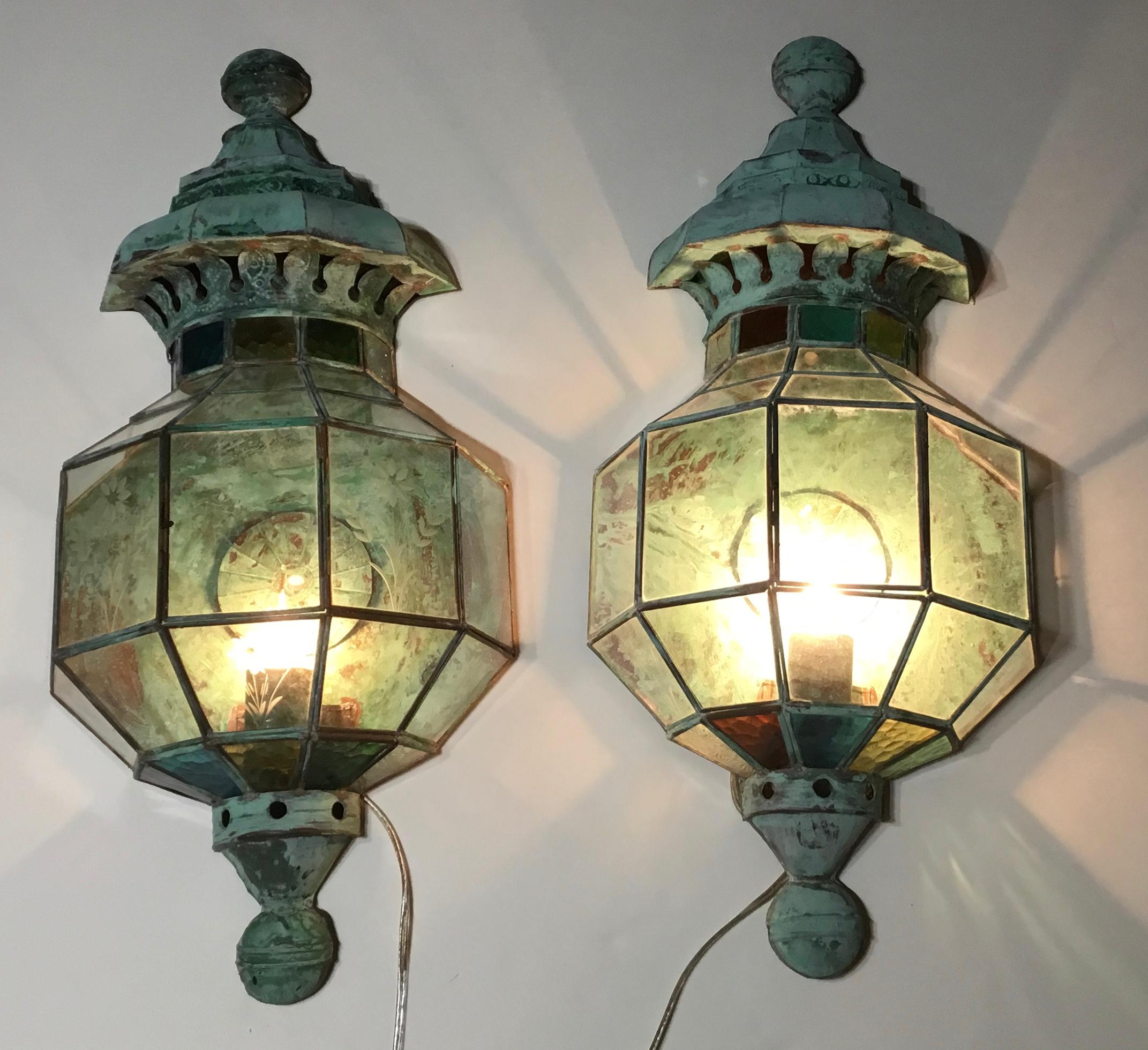 Beautiful pair of wall hanging lantern handmade from copper and embedded in some parts with
color art glass and some parts with etch glass of flowers motifs. Each lantern is with one 40/watt light.
This pair is not suitable for use in wet