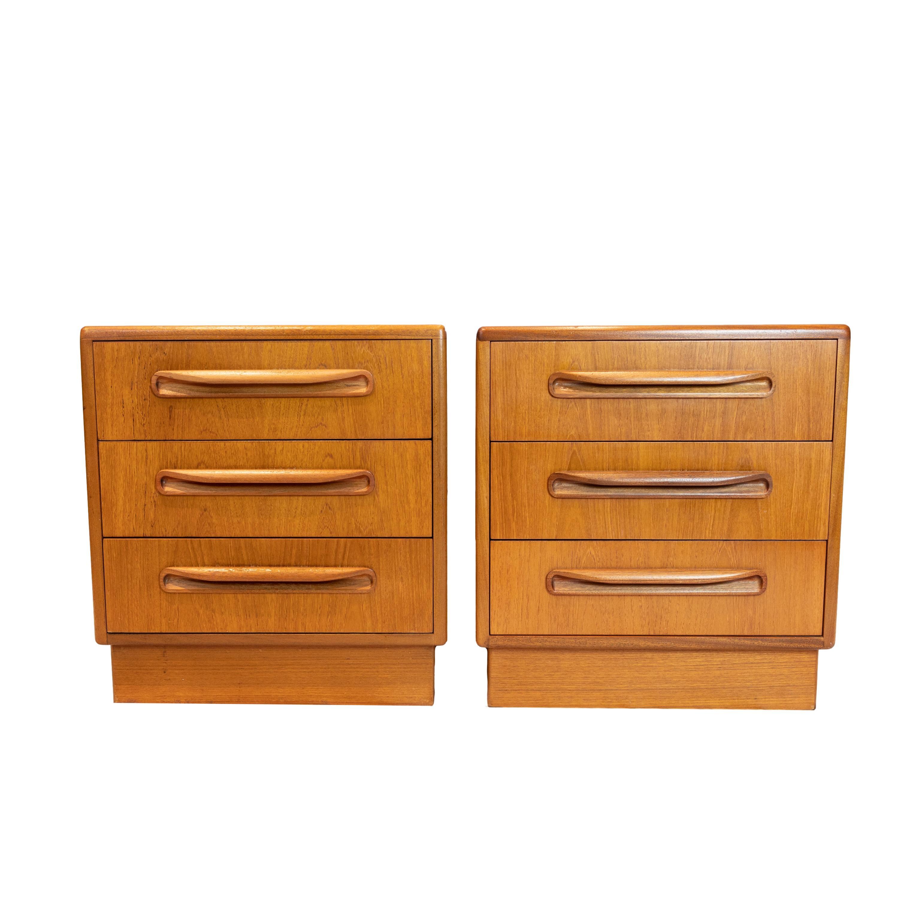 Pair of G plan teak 'Fresco' side chests by Victor Wilkins, English, ca. 1960, of cube-form, the three drawers with molded pulls, on a square plinth base, with G Plan label to the top interior drawers. 
G Plan was a revolutionary concept that