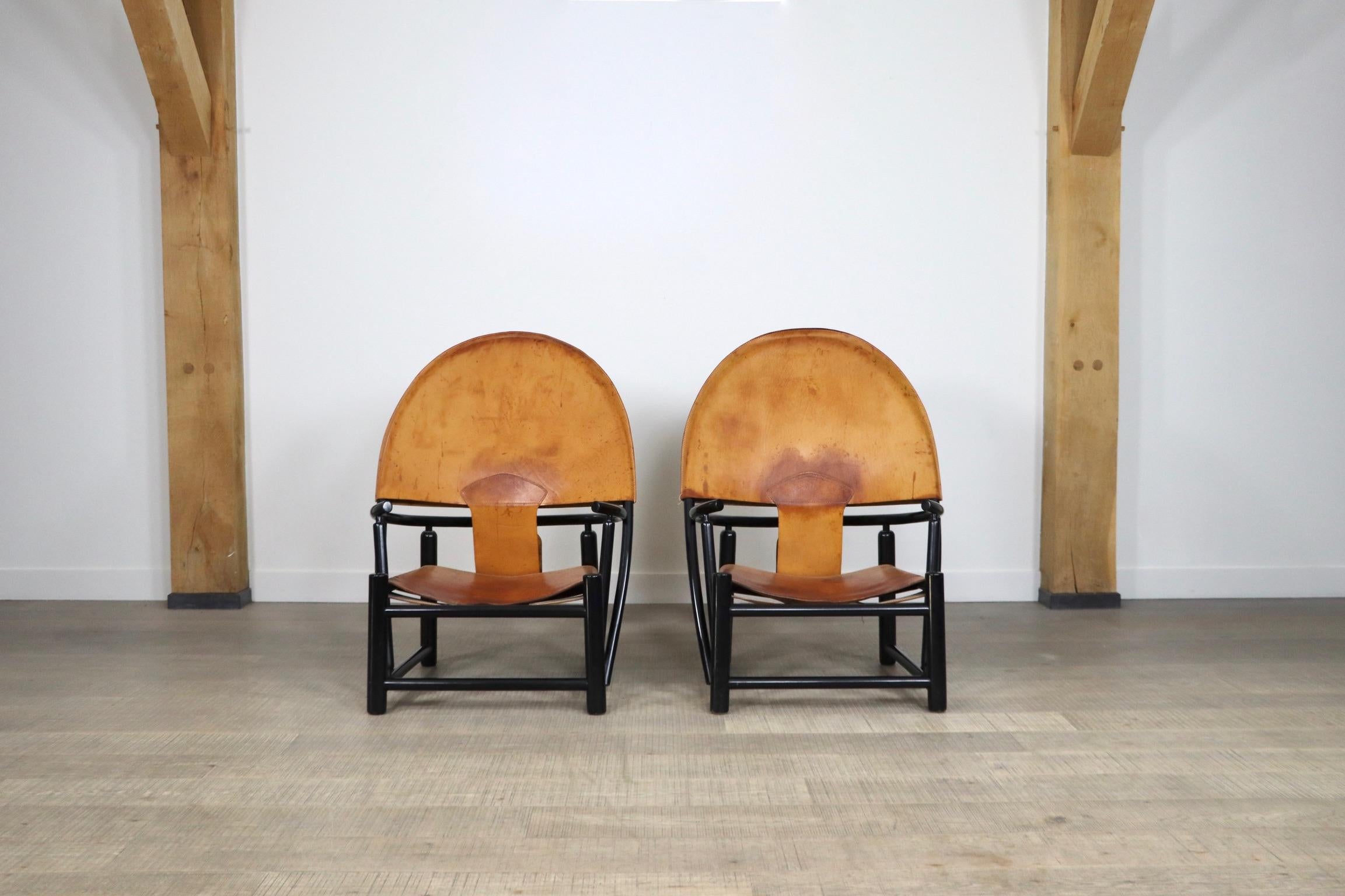 Incredible pair of model G23 lounge chairs, designed by Piero Palange & Werther Toffoloni in original patinated cognac leather upholstery and black laquered wooden frame. 
This high quality chair, with steam bent beech frame, is beautifully designed
