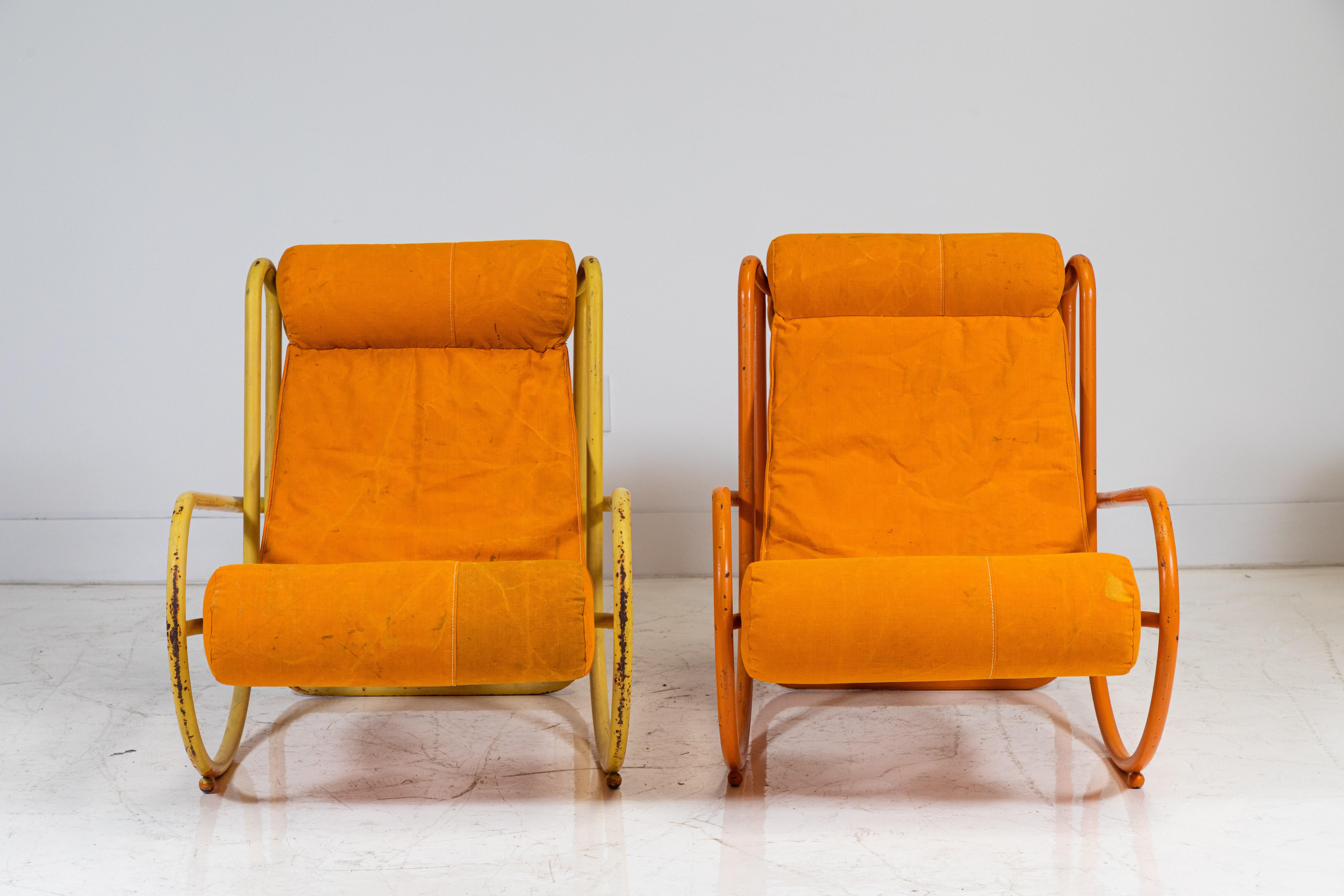We let the original details stand out for the pair of Gae Aulenti Locus Solus lounge chairs. One metal chair is yellow and the other chair is orange the original paint is untouched and the patina adds a rustic earthy element. The chairs have been
