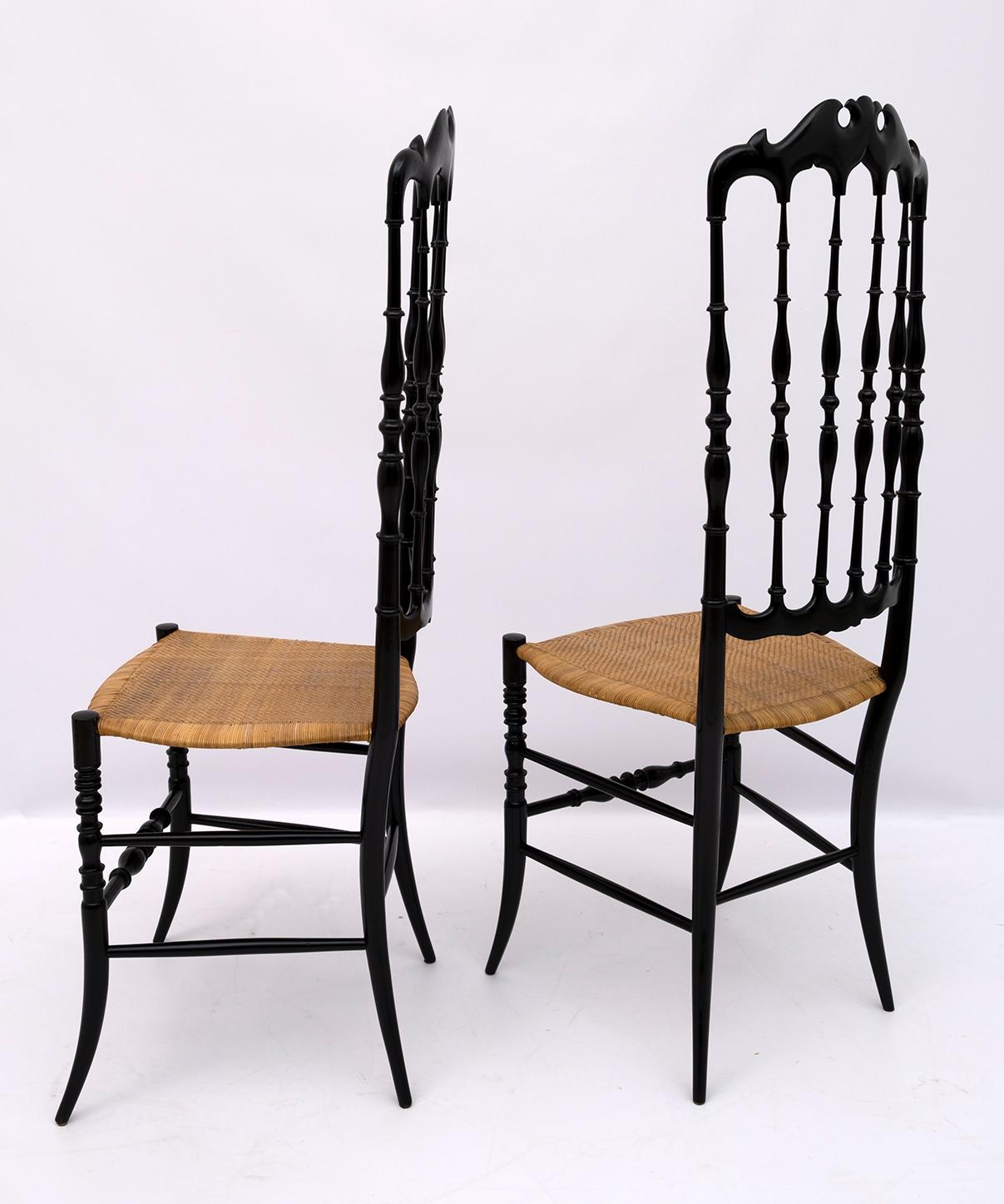 This pair of Chiavari typical chairs was designed by Gaetano Descalzi in the city of Chiavari in Italy, where they have since been produced in various models.
Made of black lacquered beech and seat in woven wicker.

Chiavari was created in 1807
