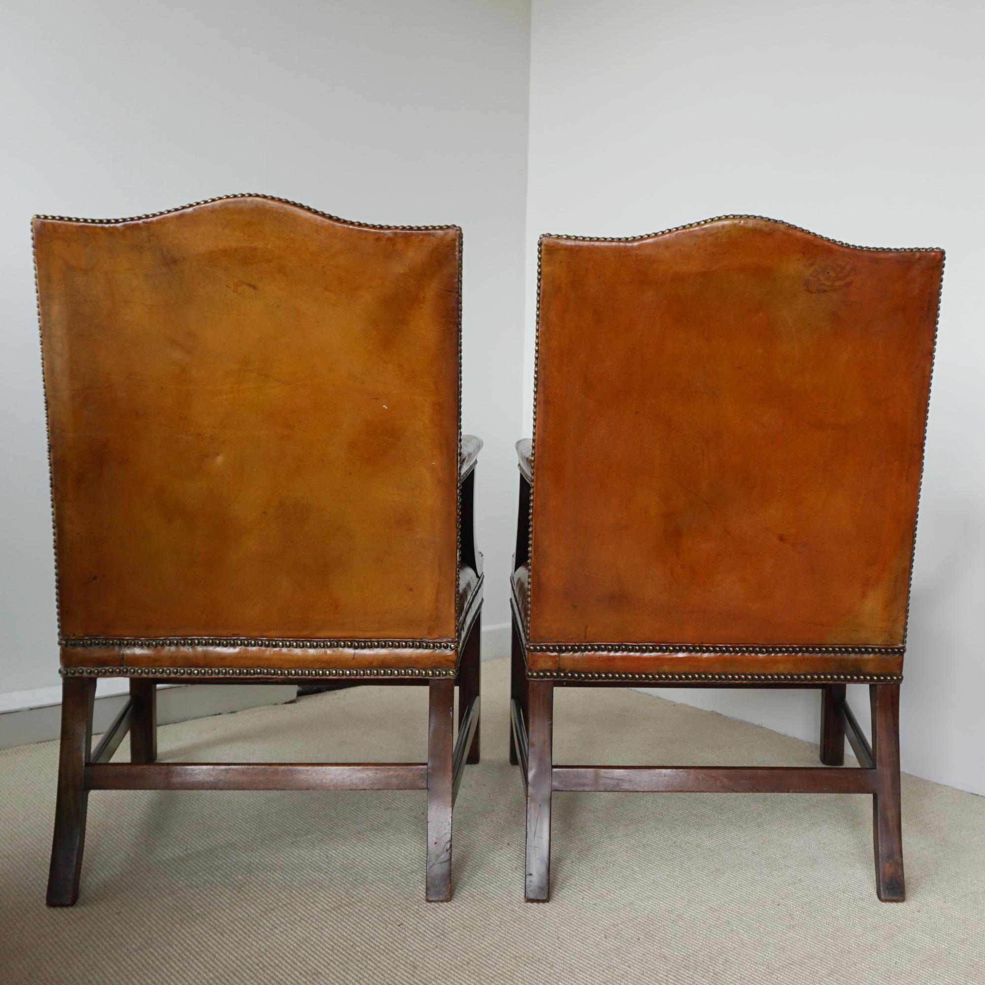 Pair of George III style Gainsborough library chairs. Vintage brown leather upholstery. with solid walnut arms and legs. 

