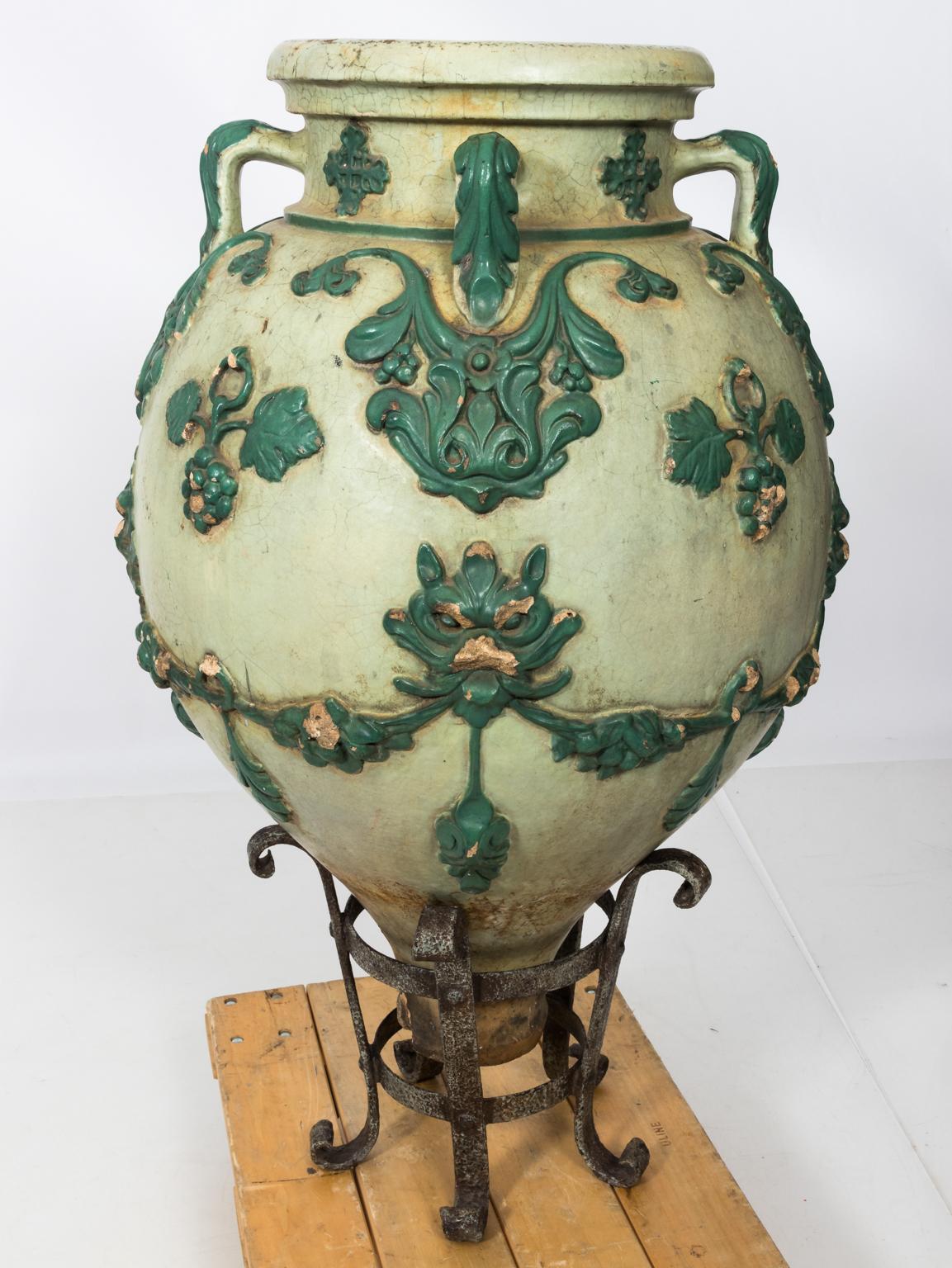 Polychrome terracotta pots in the Renaissance Revival style, hand forged iron ring bases by the Galloway terracotta company, circa 1880s. Please note of some chipping of high surfaces consistent with aging.
 
