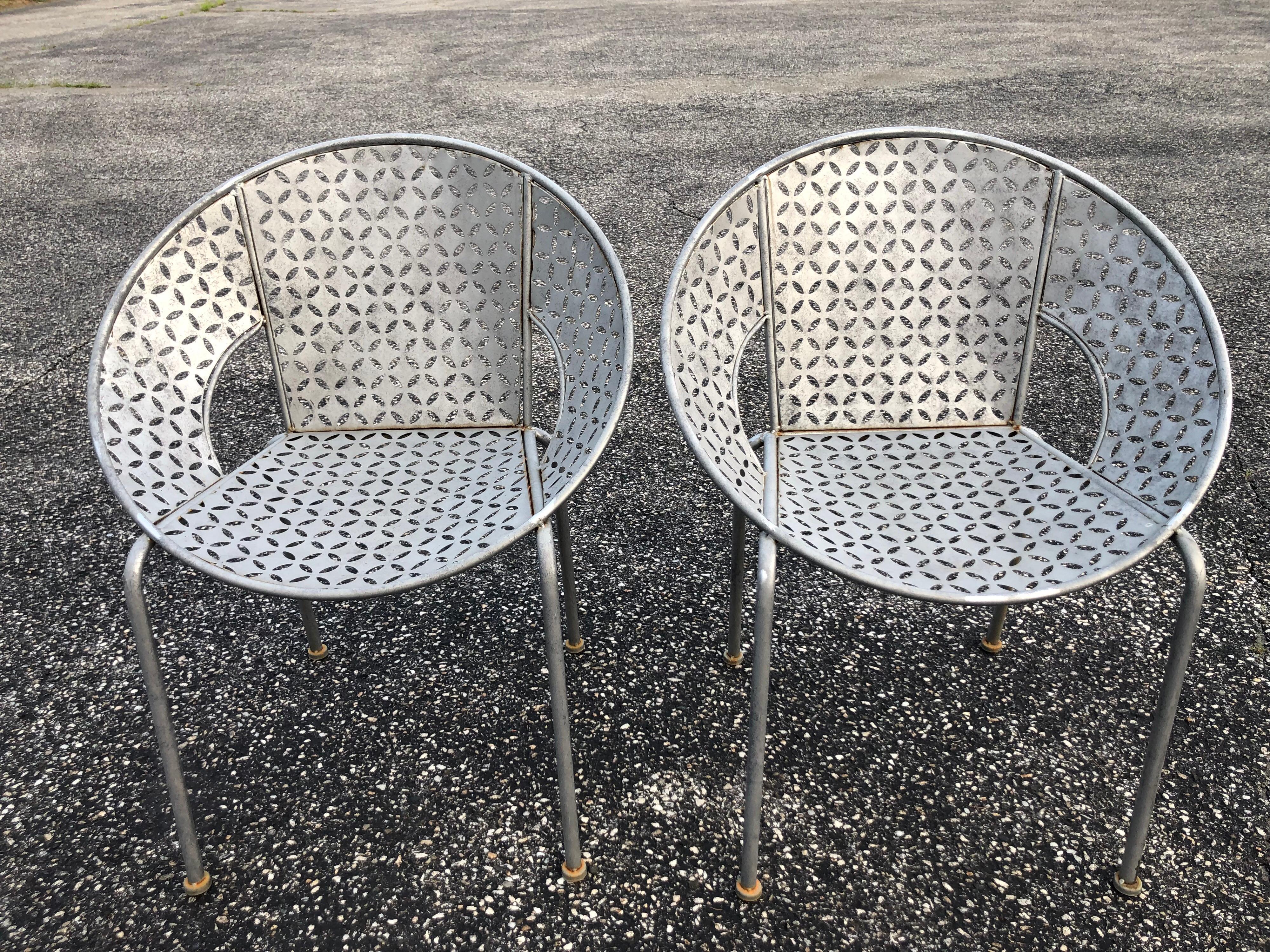 Pair of Galvanized steel saucer chairs. Simple, Minimalist, atomic style. Great for in or outdoor. We think these are a current reproduction in the style of a salterini clam shell chair.
