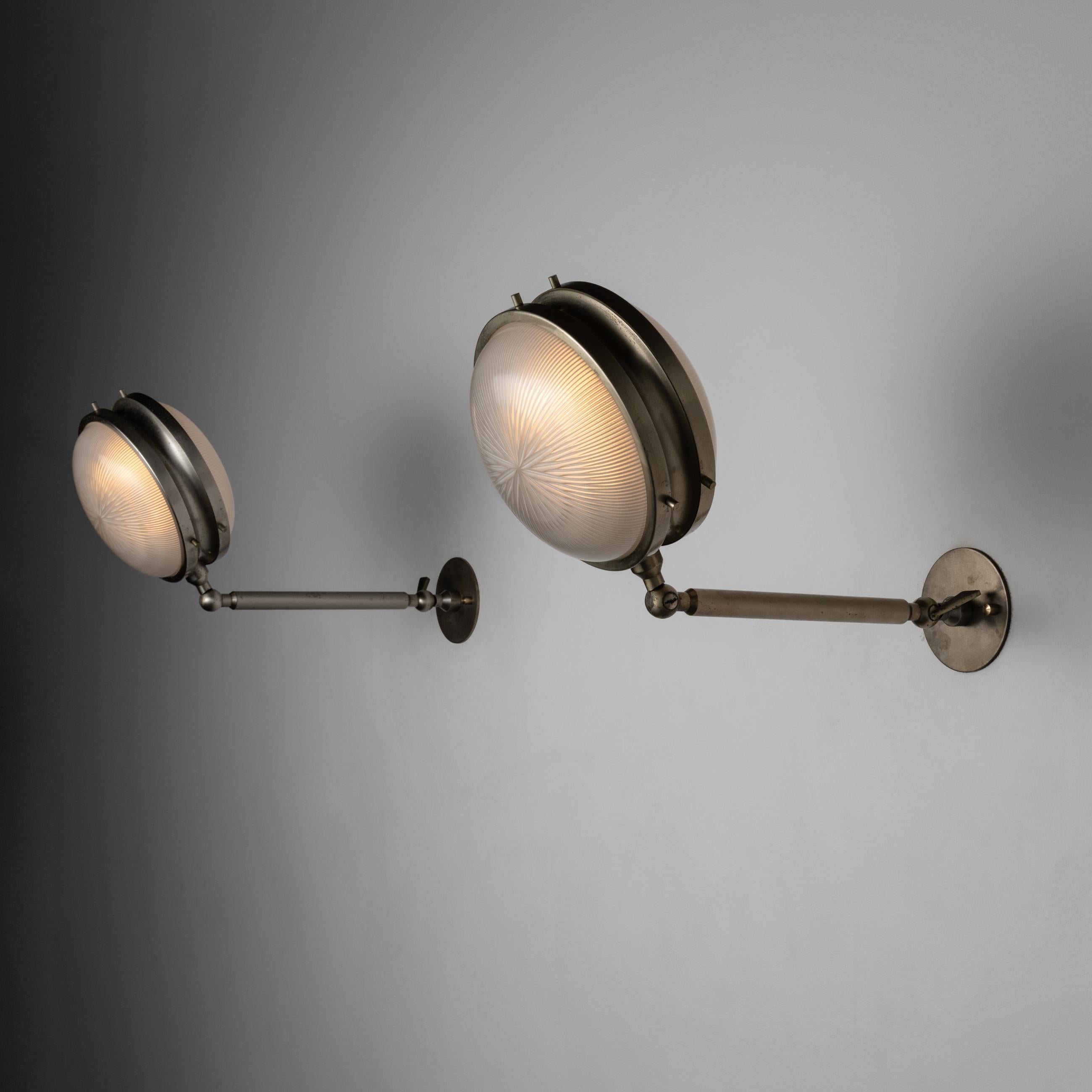 Pair of “Gamma” Sconces by: Sergio Mazza for Artemide. Designed and manufactured in Italy, circa 1960's. Brass, glass. Rewired for U.S. standards. Arms adjust to various heights. We recommend one e27 40w maximum bulb per fixture. Bulbs not included.