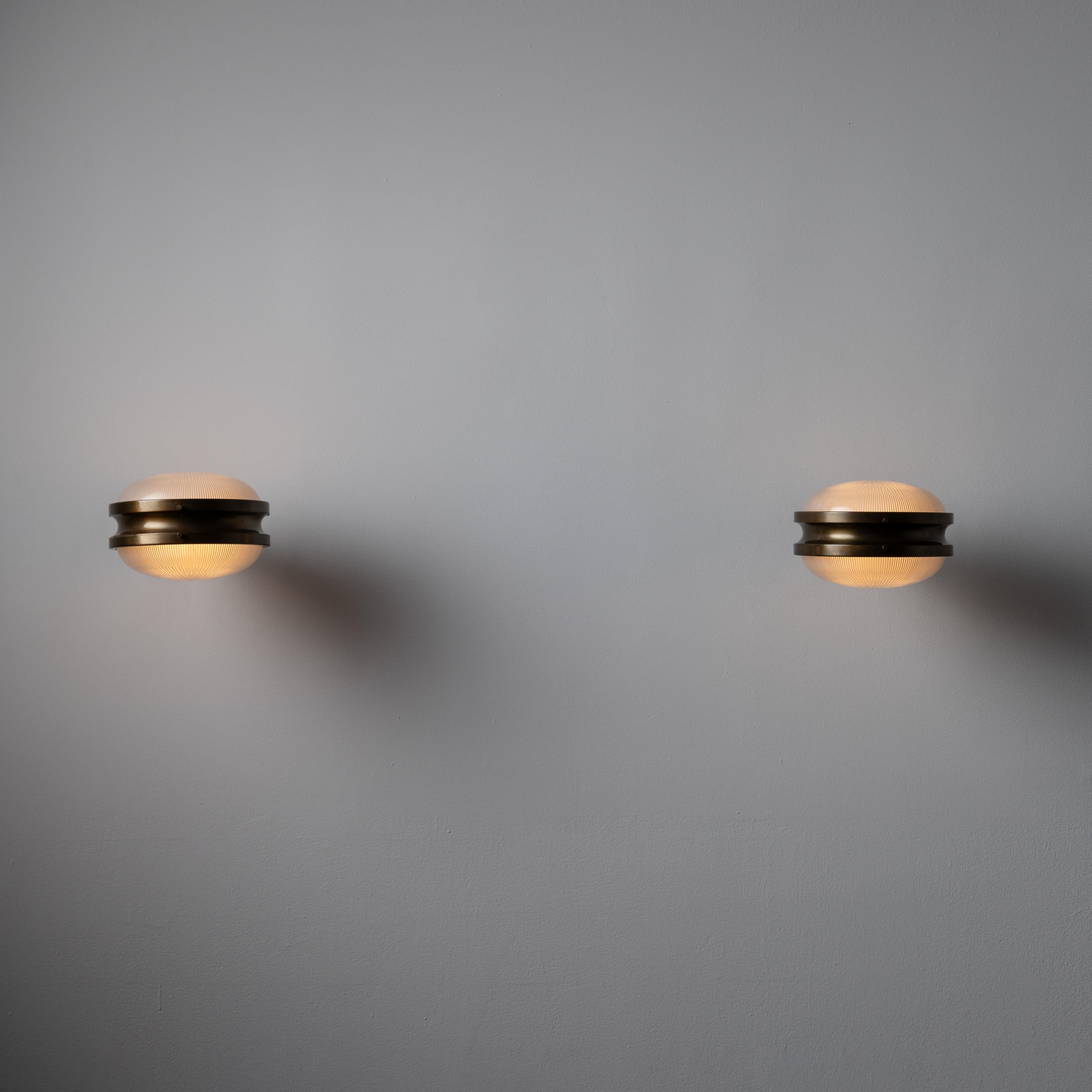 Pair of “Gamma” Sconces by: Sergio Mazza for Artemide. Designed and manufactured in Italy, 1962. Brass and reeded glass. Rewired for U.S. standards. We recommend one 40w maximum bulb per fixture. Bulbs are not included. Sold as a set.