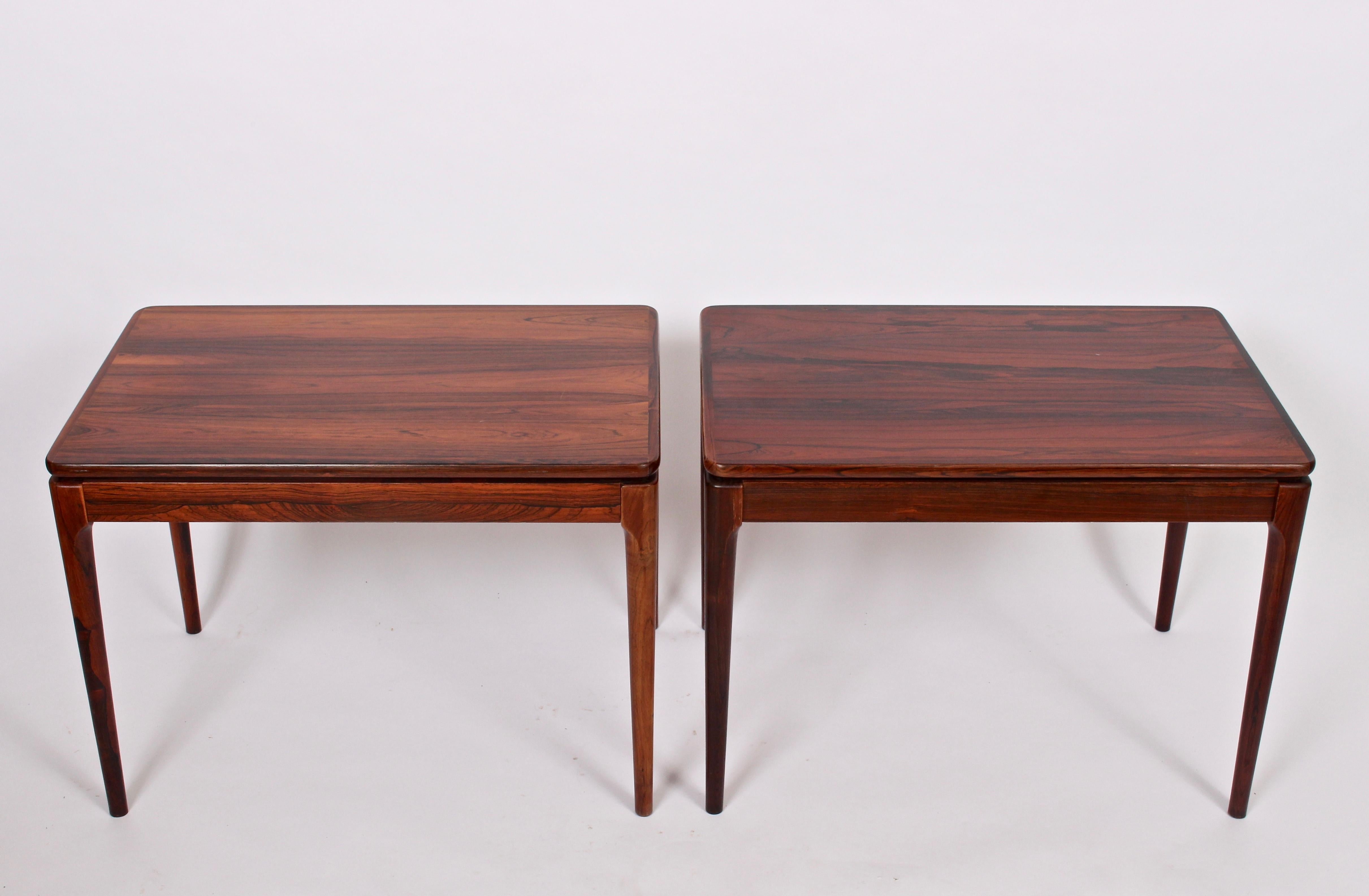 Pair of Norwegian Modern Ganddal Mobelfabrikk rosewood side tables, bedside tables. Featuring a rectangular form in solid rosewood with slotted vertice detail between turned solid rosewood legs and surface. Common rosewood color variation seen in
