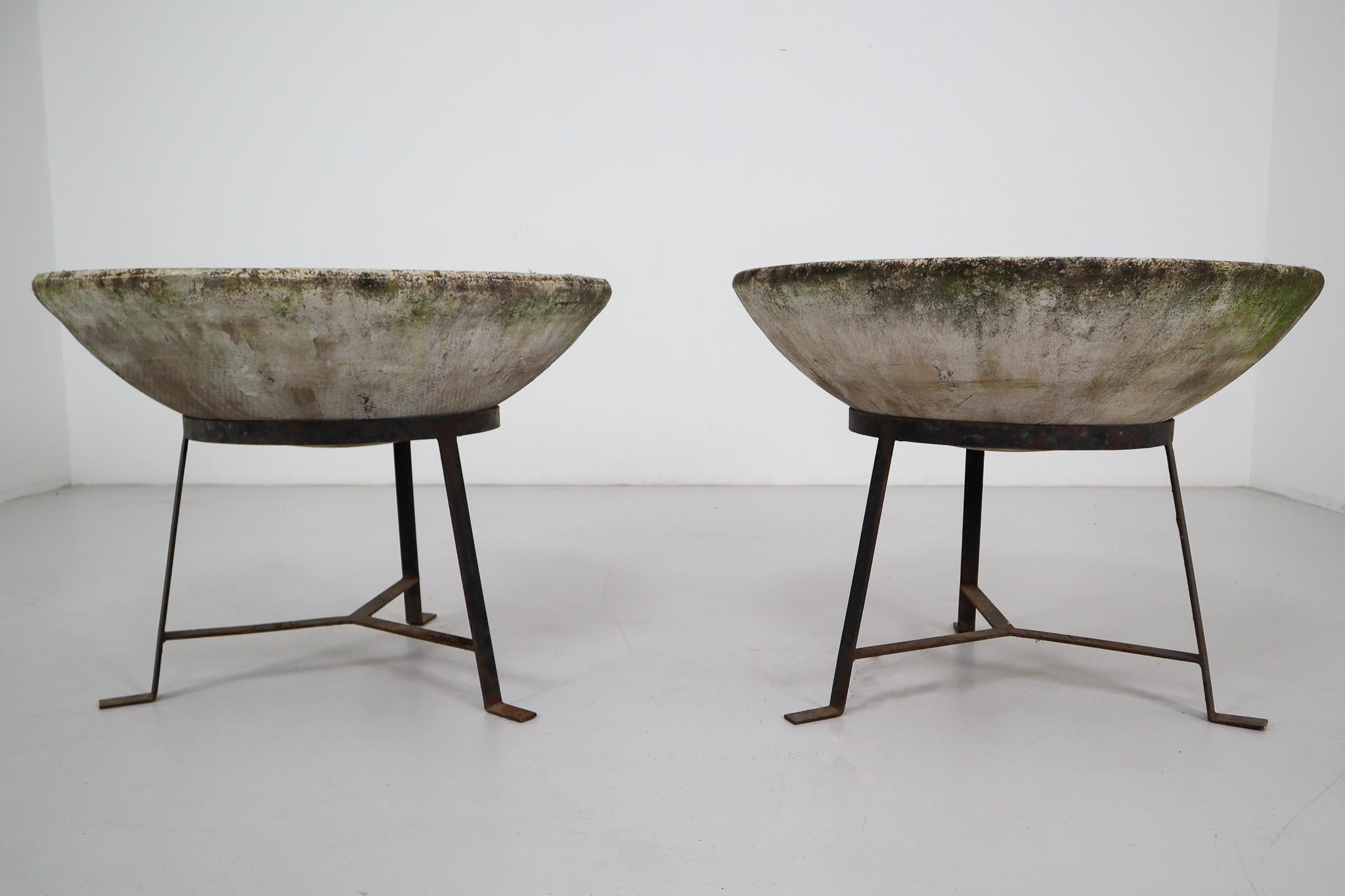 A fine pair of Mid-Century Modern large saucer planters of composition stone for an indoor or outdoor garden, garden room, or terrace, designed by the iconic Willy Guhl in the early 1960s. They have a lovely naturally-weathered surface.