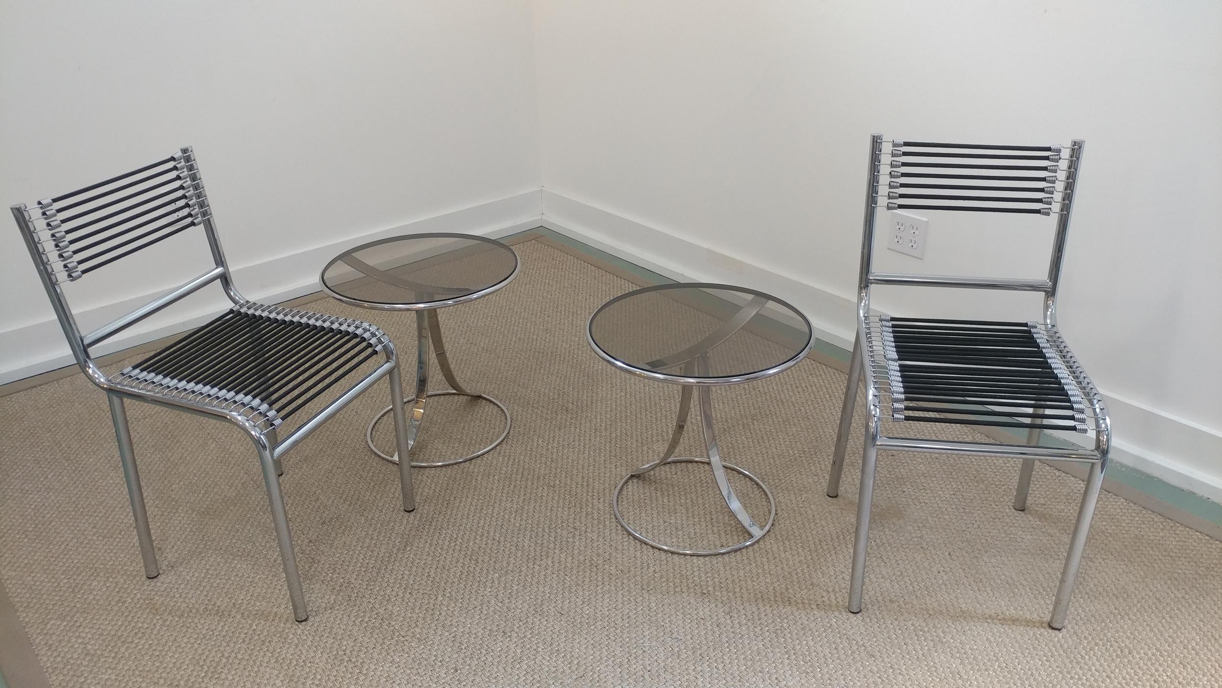 A pair of great looking modern side cocktail tables by Gardner Leaver for Steelcase, circa 1970s. Smoke glass on stainless sculptural frame. In all original overall good condition despite one of the glass's edge have small chip. But its not