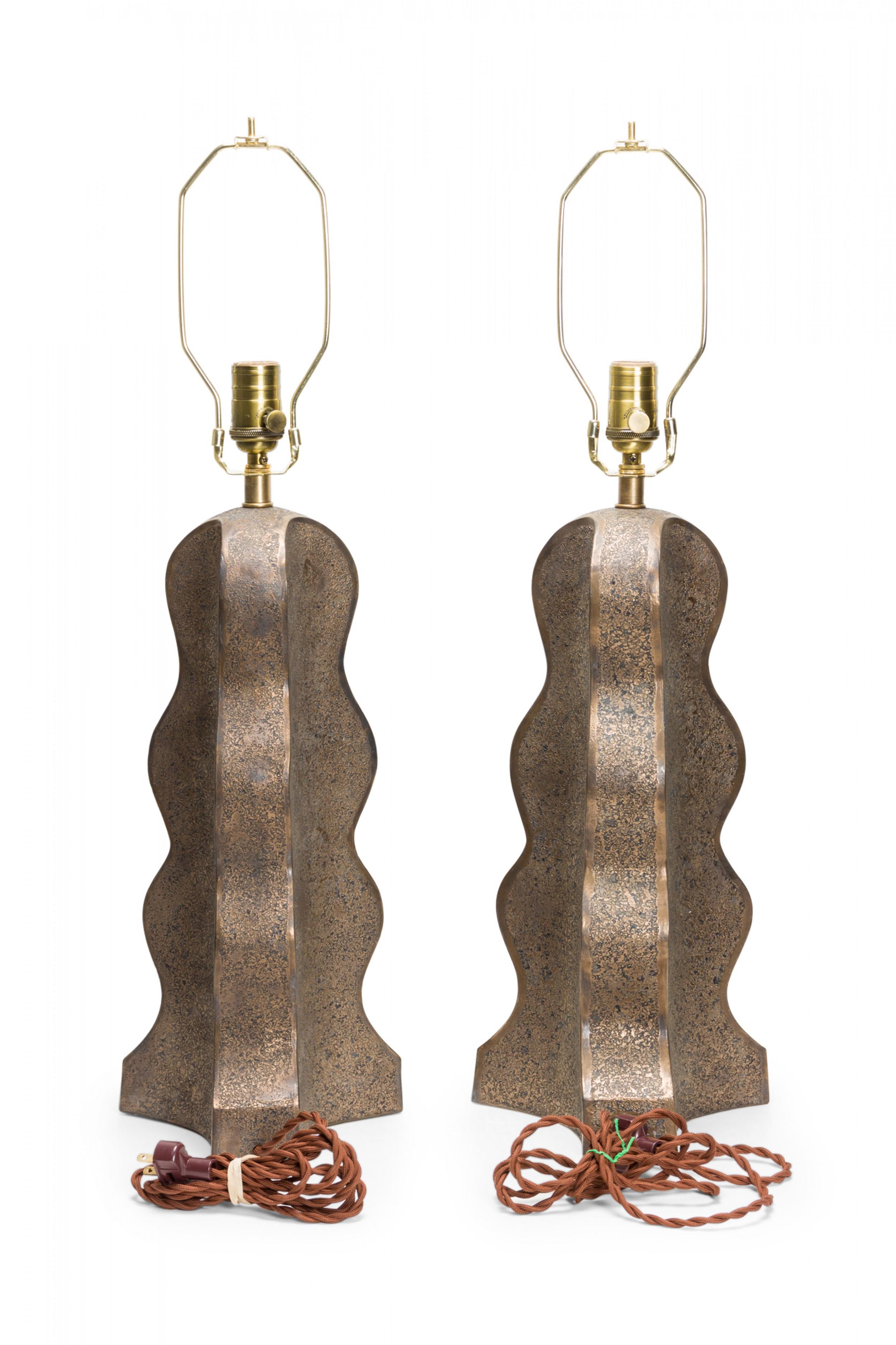 Pair of Contemporary hand-built ceramic table lamps with lobed forms and textured bronze glaze, mounted with brass hardware and topped with white fabric lamp shades. (Gary Dipasquale).