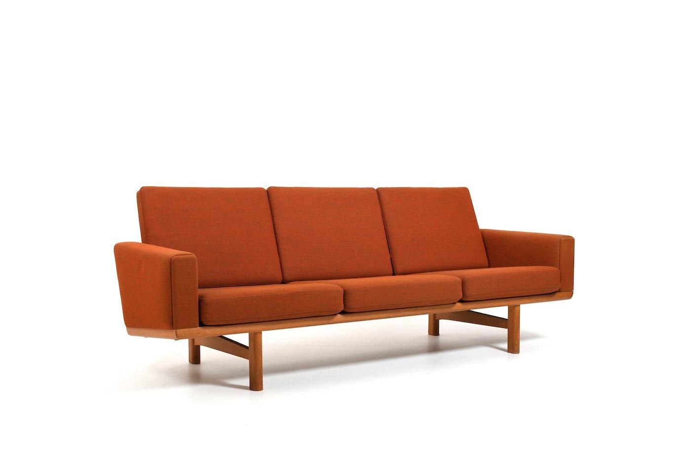 Pair of GE-236 / 3 sofas in solid oak, designed by Hans J. Wegner in 1955. Manufactured by Getama in 1960s. Original cushions and orange/grey wool fabric by Ryghynde Denmark. This set comes from the same house and it´s in very good vintage
