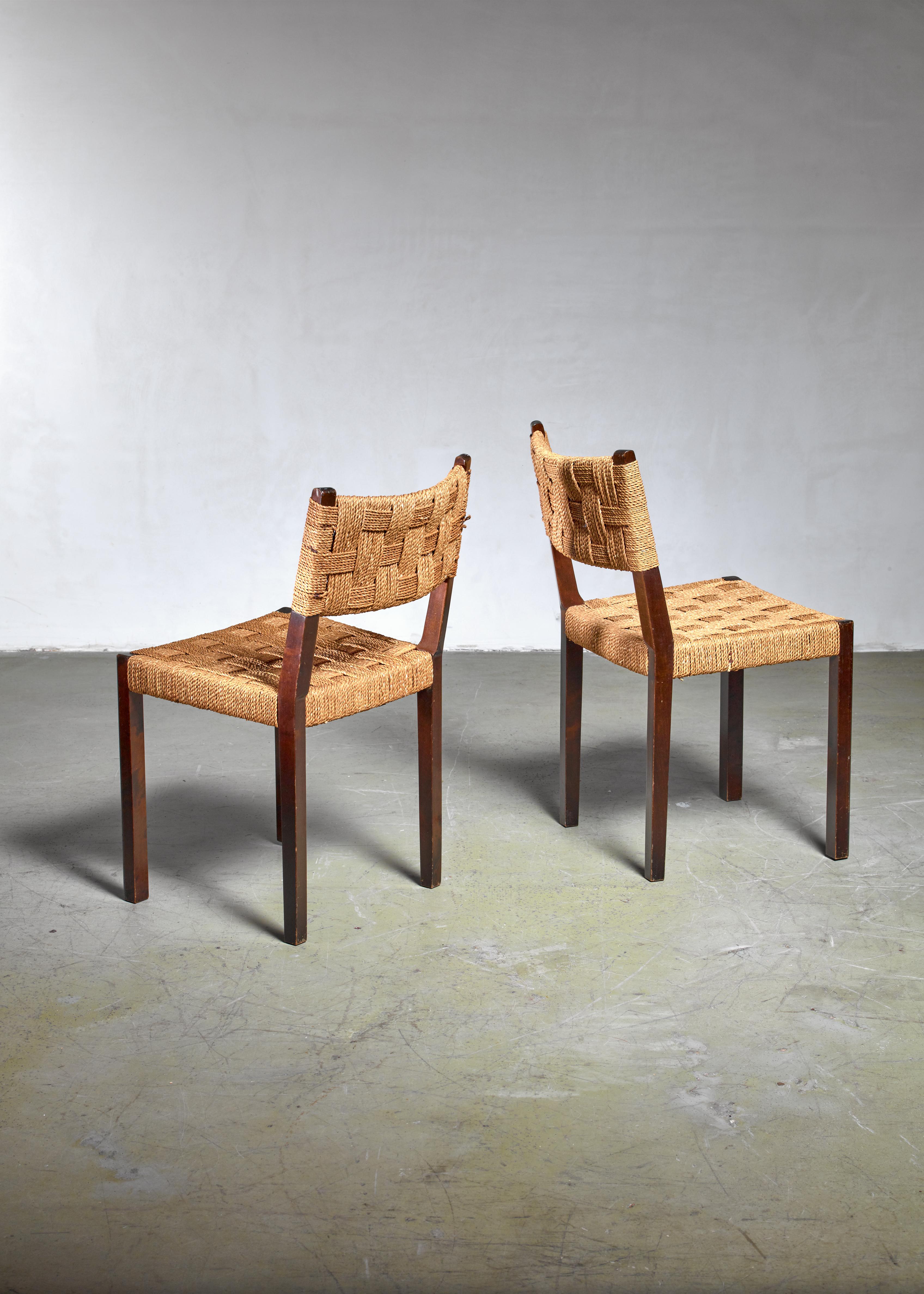 A pair of beech side or dining chairs with a woven rope seating and backrest, produced by Gemla.

Labelled by Gemla and in a very good condition.