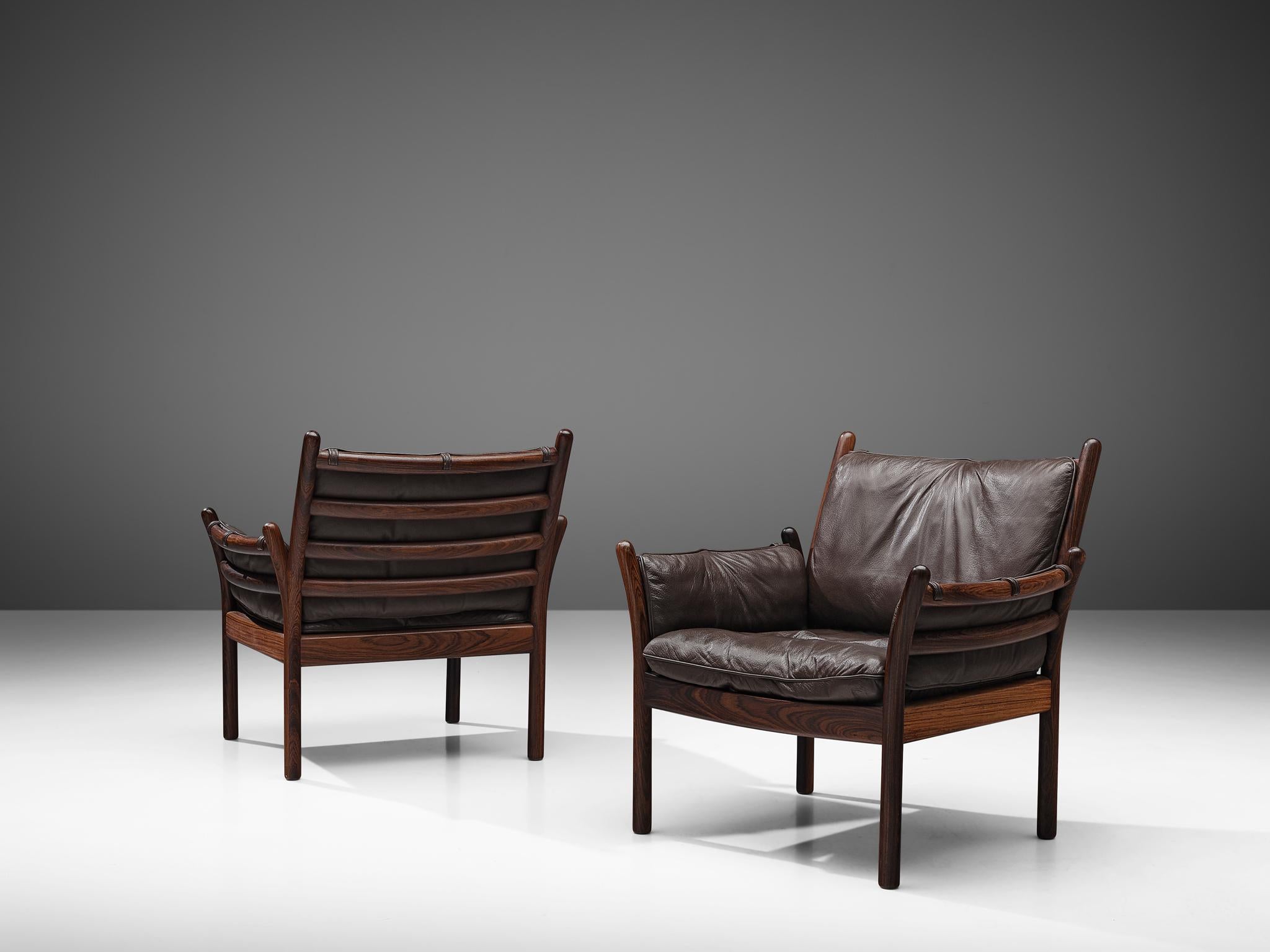 Illum Wikkelsø by CFC Silkeborg, two 'Genius' chairs, leather and rosewood, Denmark, 1950s.

This chair is made out of solid rosewood and features a cognac leather cushion on both seat and back. The chair is created as a sort of slatted rosewood