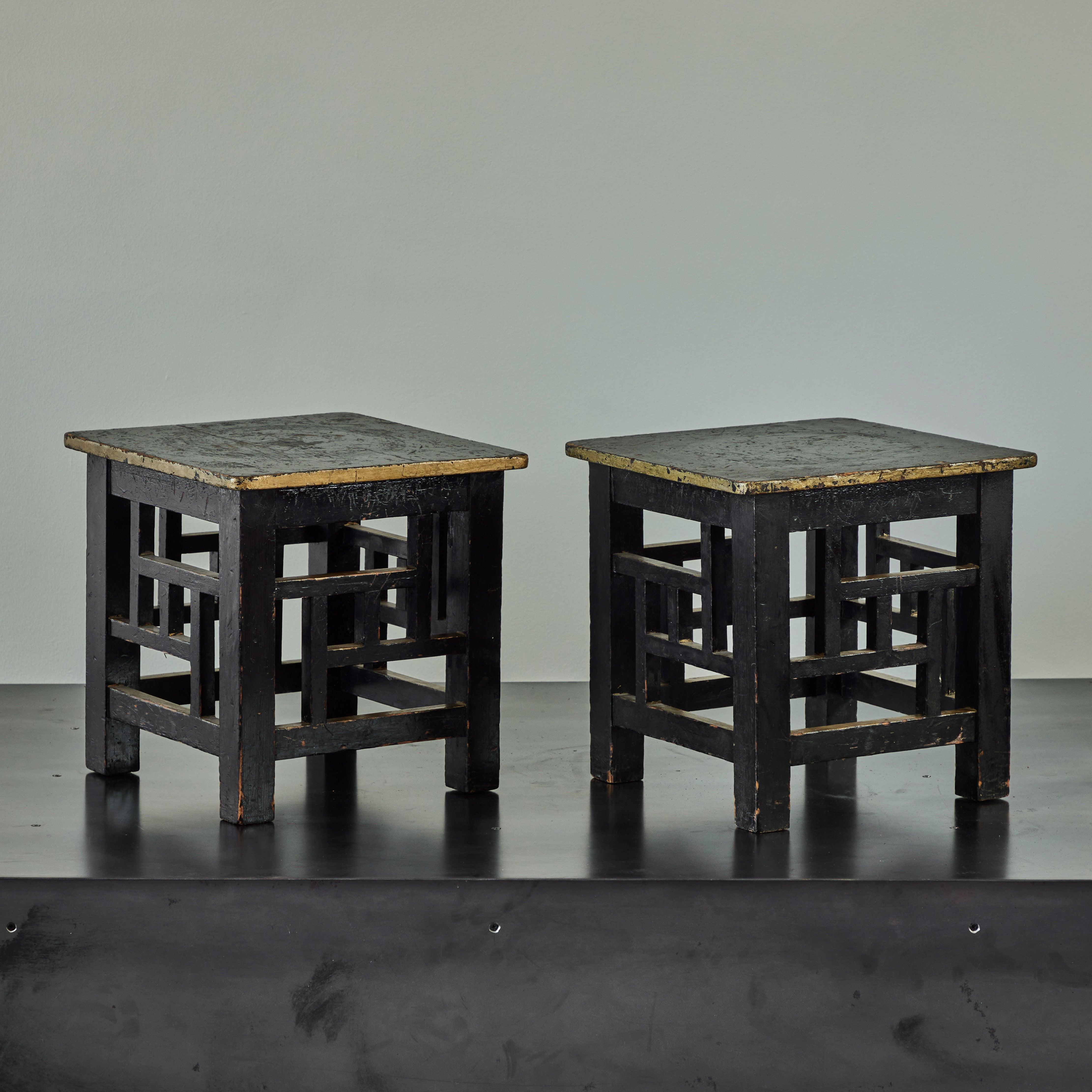 Pair of English late 19th-century occasional tables or stools in the Aesthetic Movement style. Featuring ebonized wood framework with traces of gilt decoration, the set has a beautiful patina. Spare, geometric, and with a strong commitment to