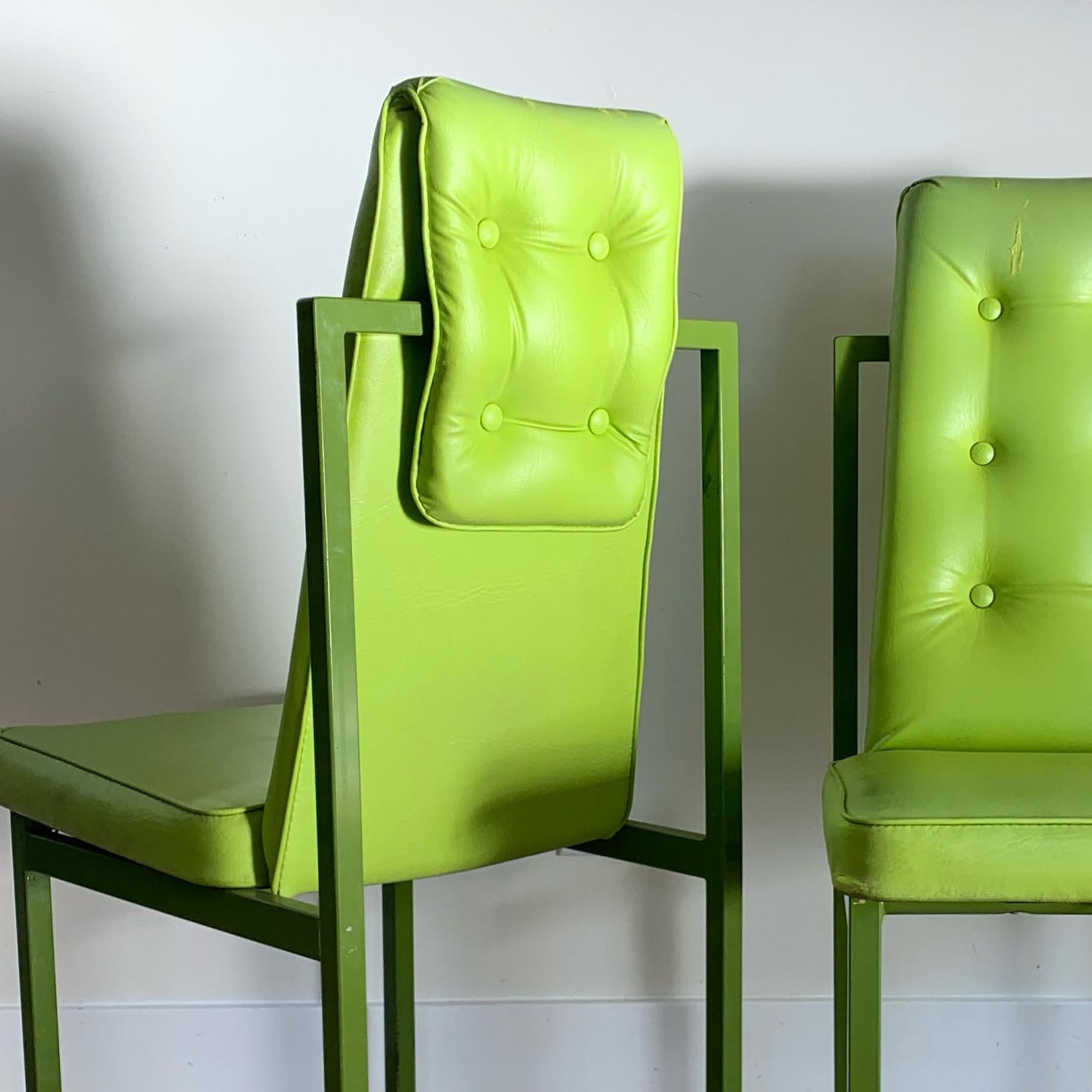 A pair of structural mid century Cal-Style chairs with powder coated grass-green frames and chartreuse leather upholstery. Circa mid 70s. Signs of wear (repaired upholstery in both tops, as well as minor wear to frames) but overall good vintage