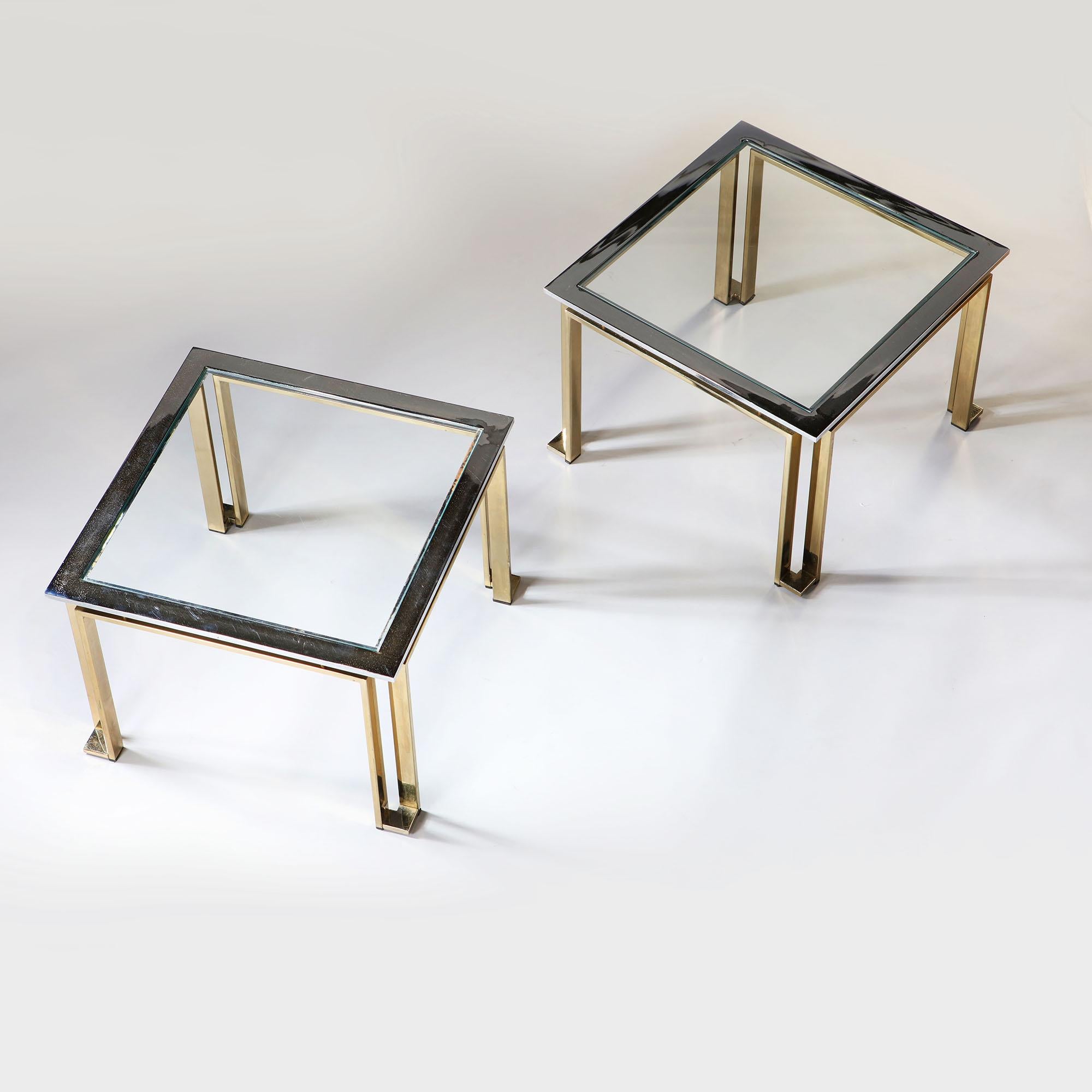 A pair of 20th century chrome and brass occasional tables with glass tops, of geometric form.